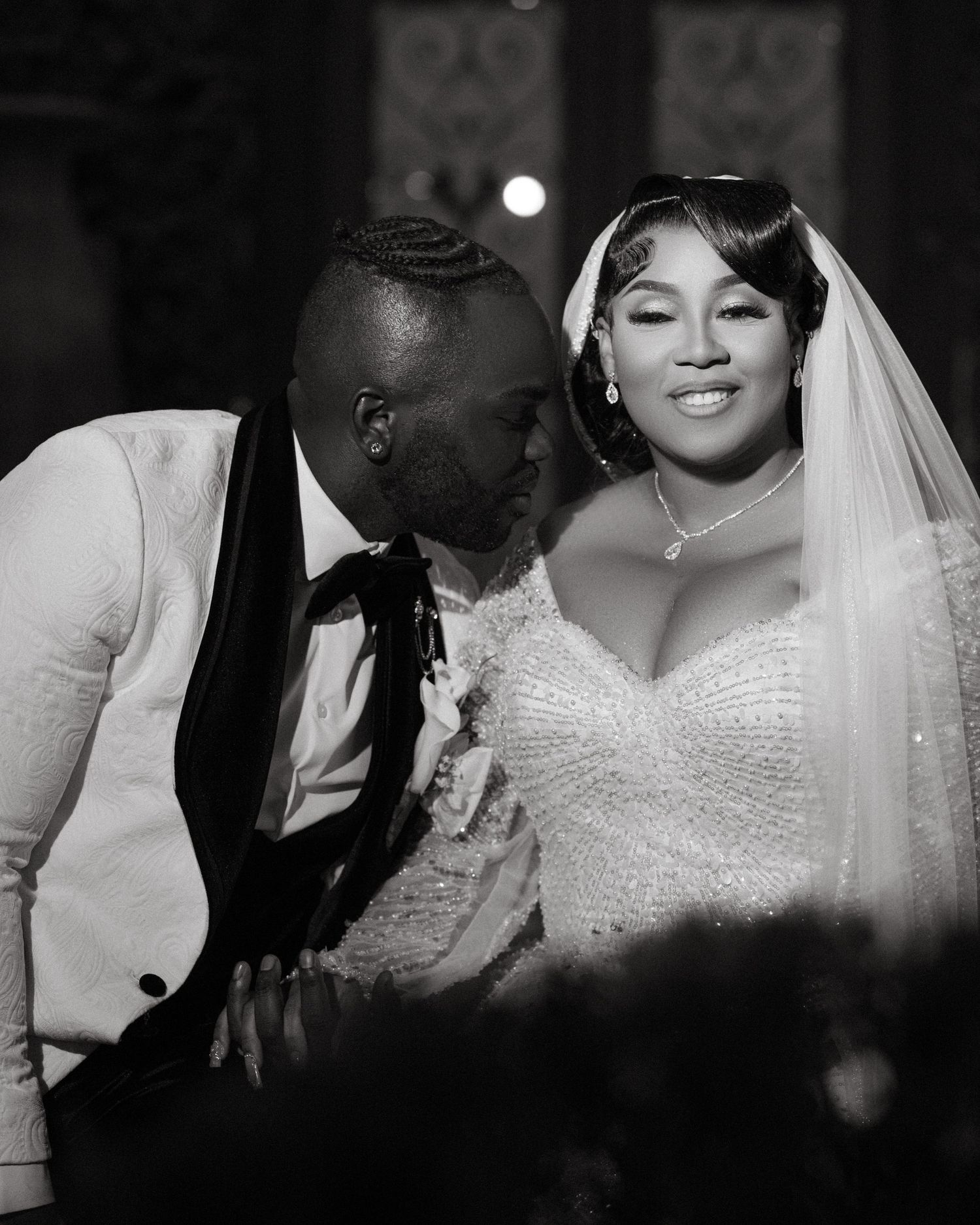 Black and white wedding photos showing intimate moments between newlyweds.