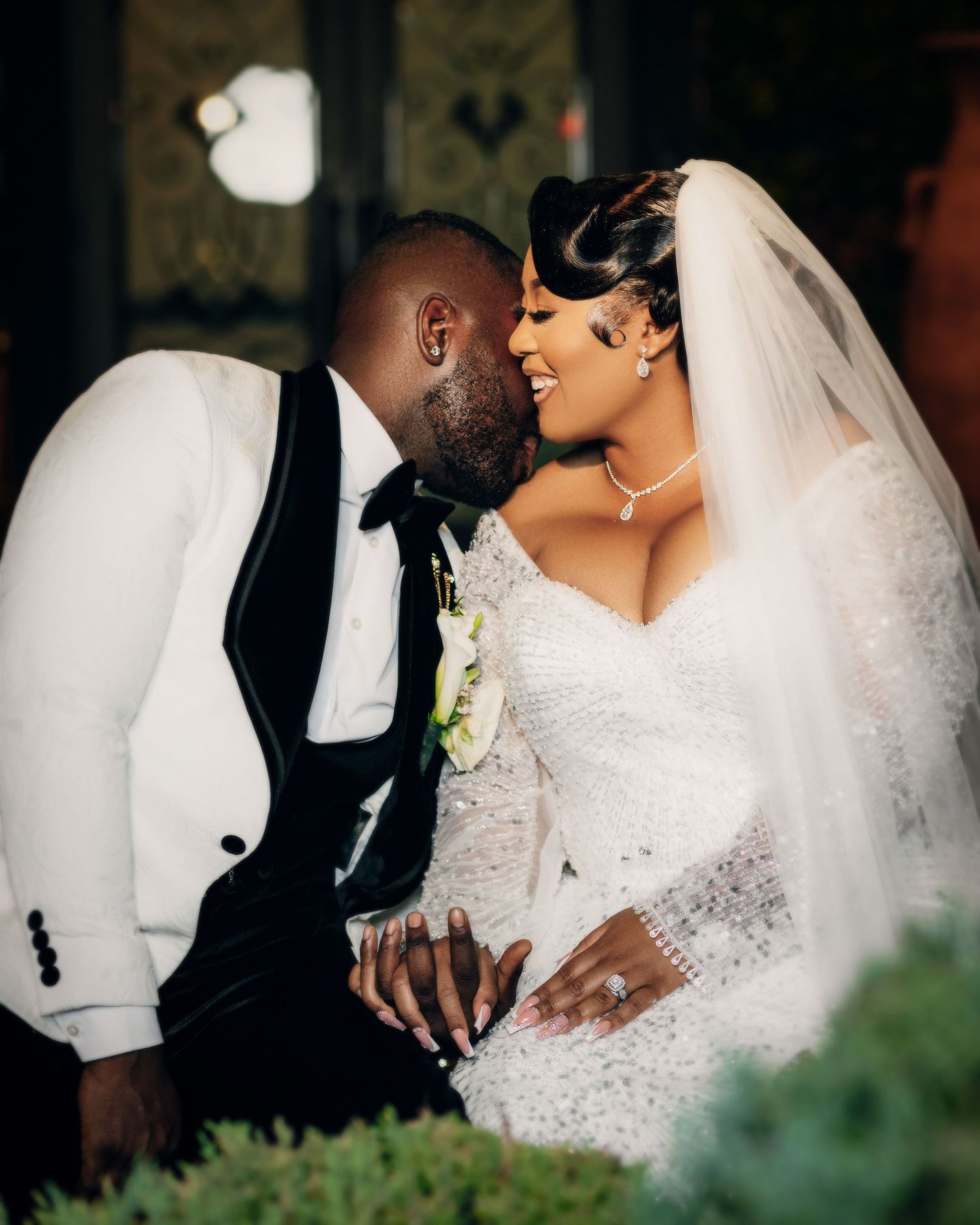 Intimate wedding portraits showing tender moments between newlyweds in an outdoor garden setting.