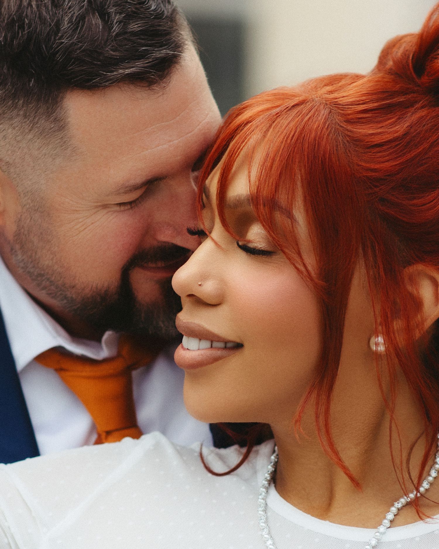 A couple shares an intimate moment in a series of romantic close-up shots showing affection and smiles.