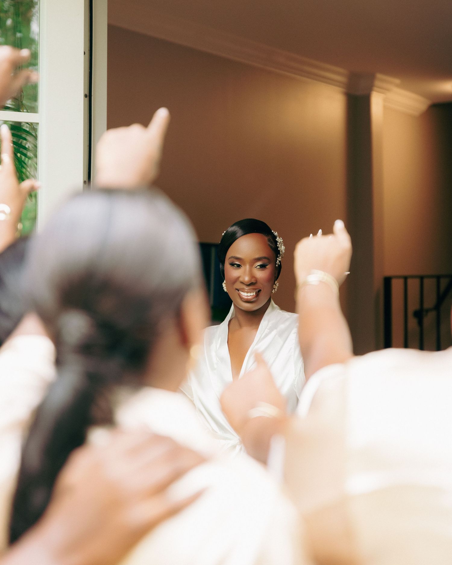 Getting ready scene with soft natural lighting through windows during wedding preparations.