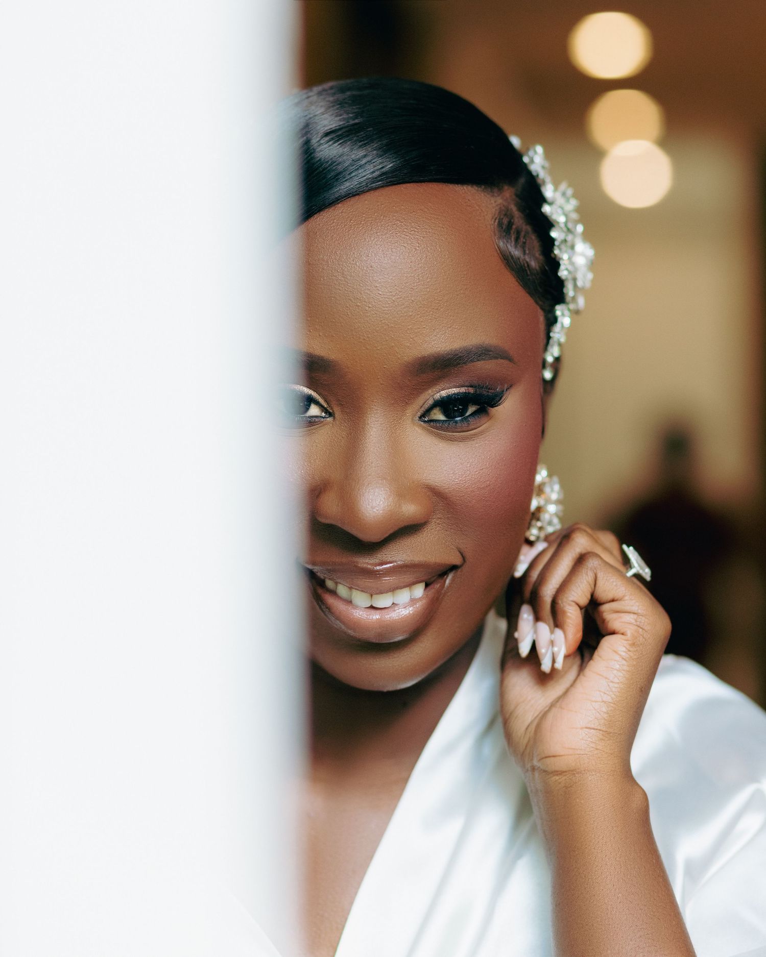 Bridal beauty portrait showing elegant makeup and jewelry details.