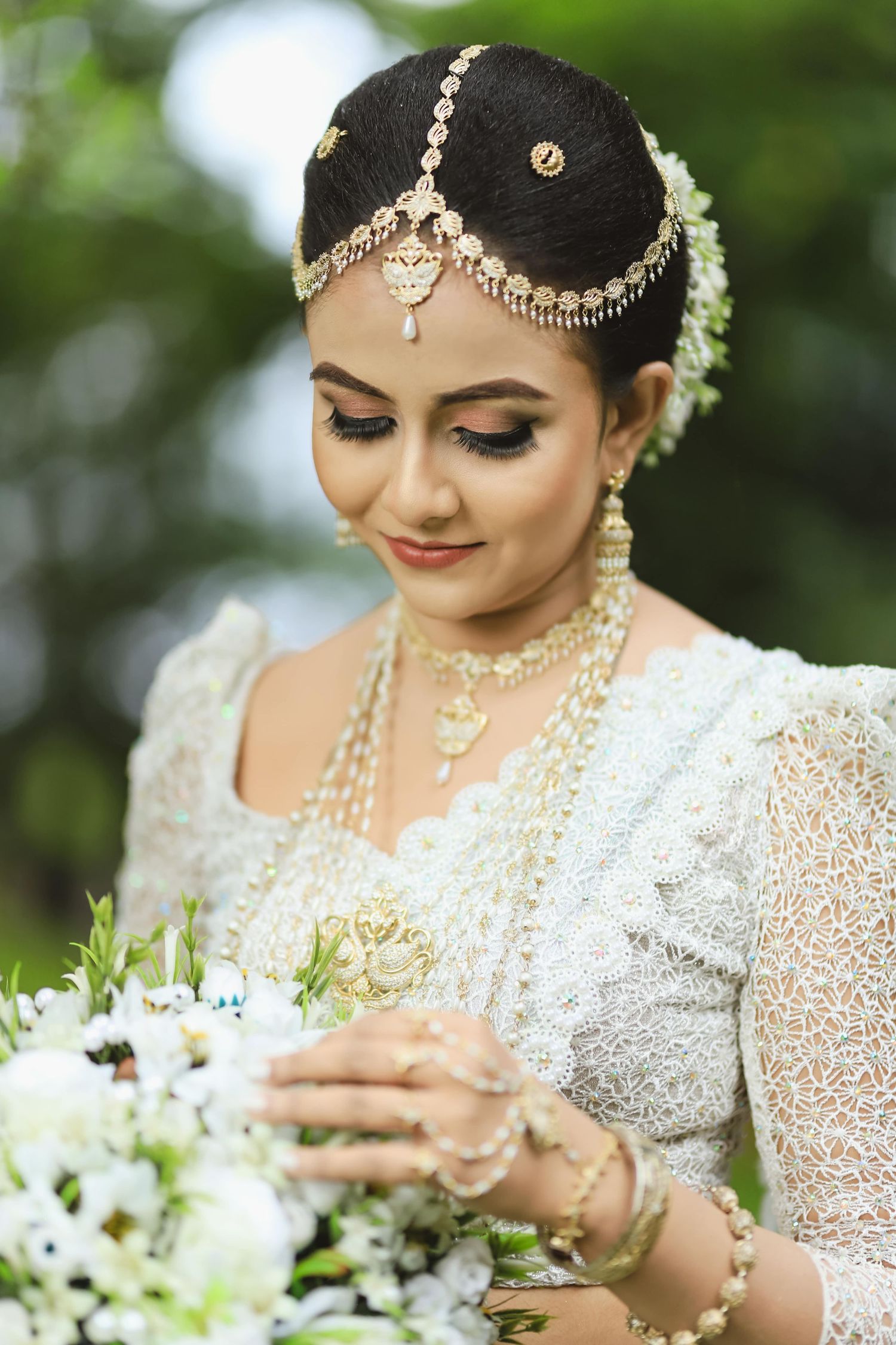 Close-up shots of bridal details featuring traditional jewelry and white floral arrangements.