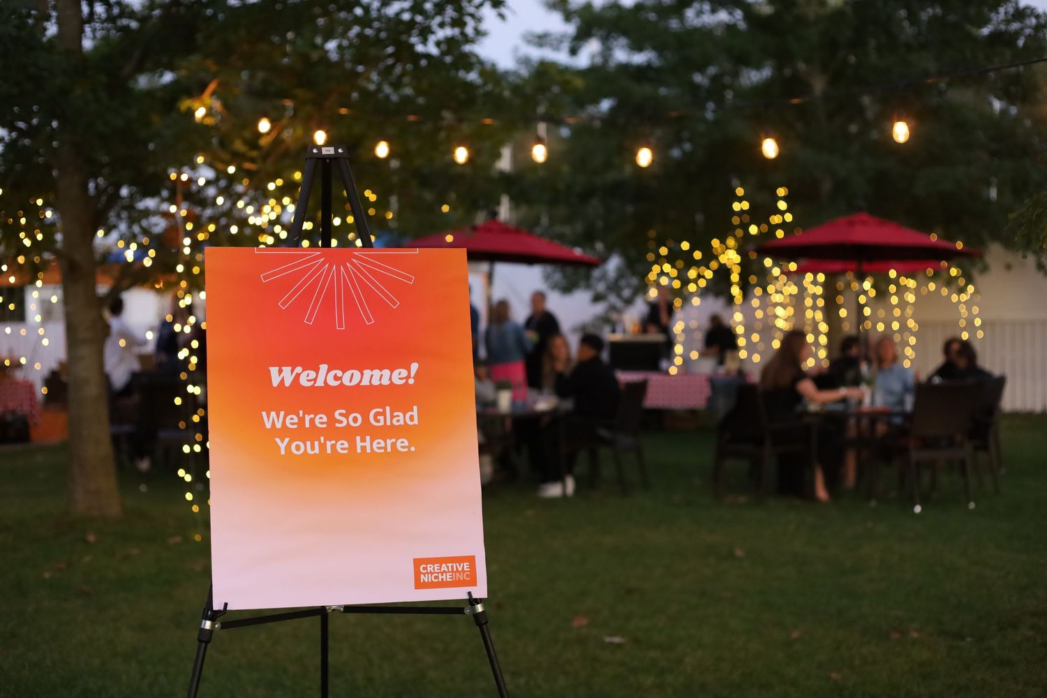 corporate outdoor event scene with party of people in the distance