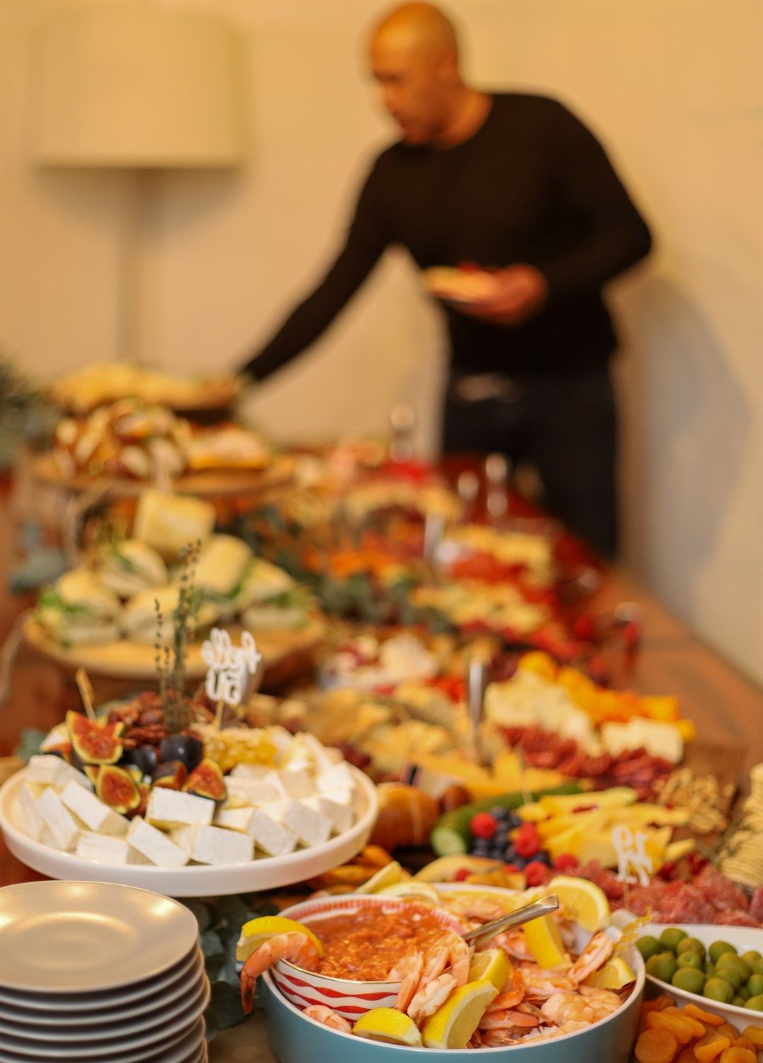a person at an event serving himself food at the beautiful gathering table