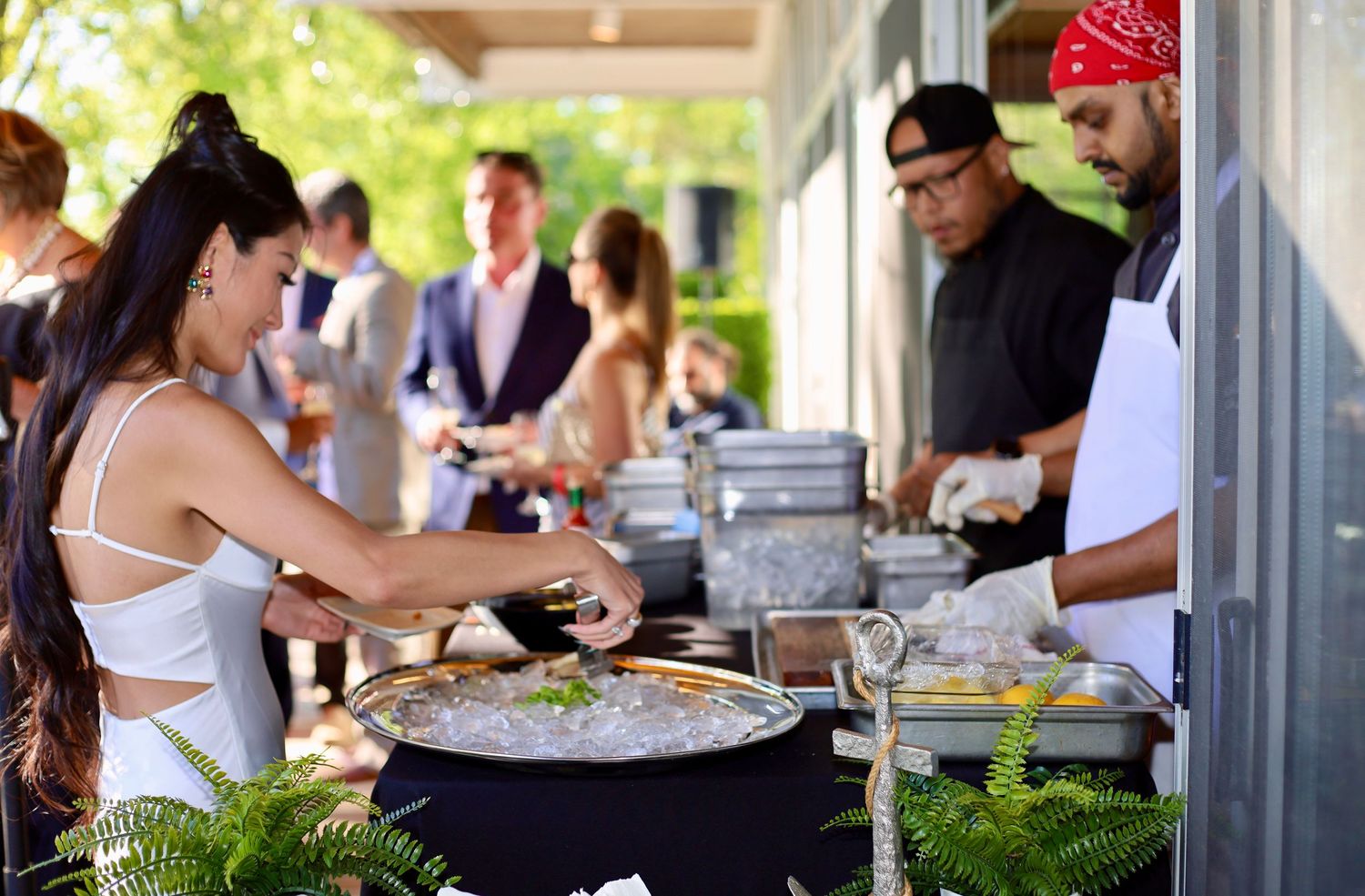 a guest at a party, serving herself some food at a chef station