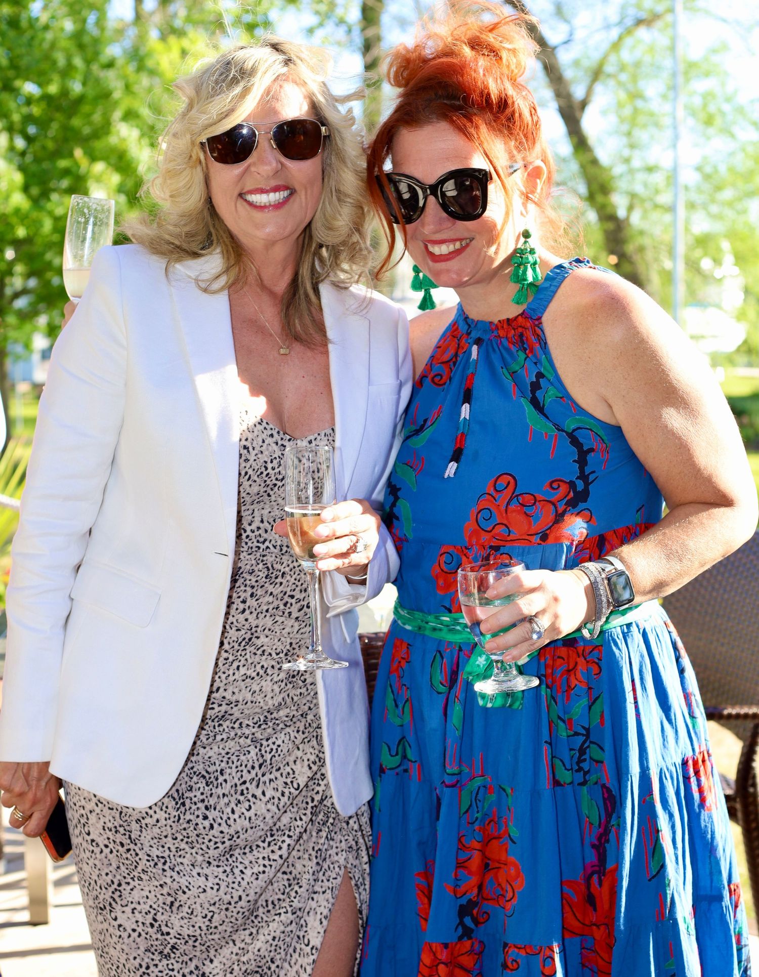 two people posing at an outdoor summer event