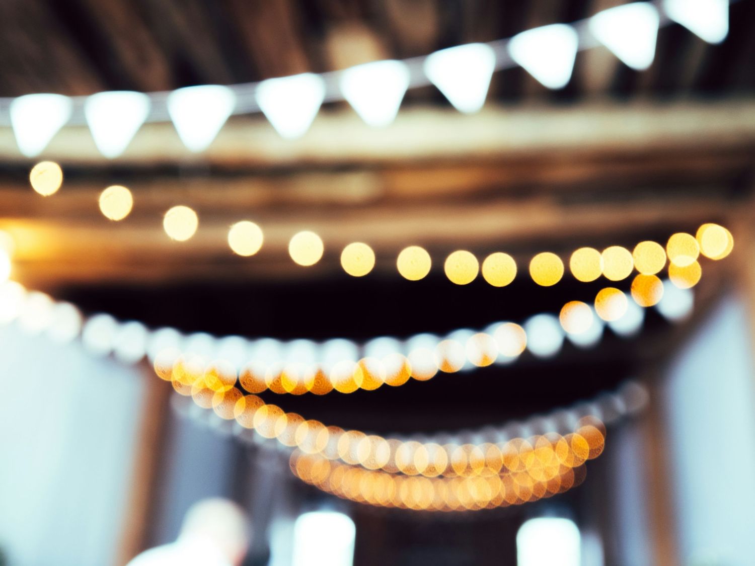lights and streamers hanging from the ceiling at a party