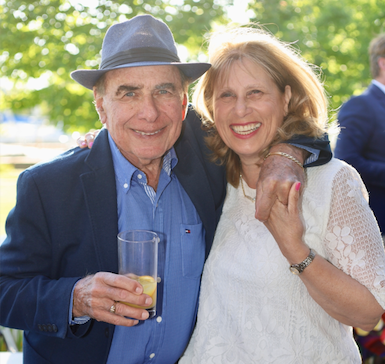 two people posing at an outdoor summer event