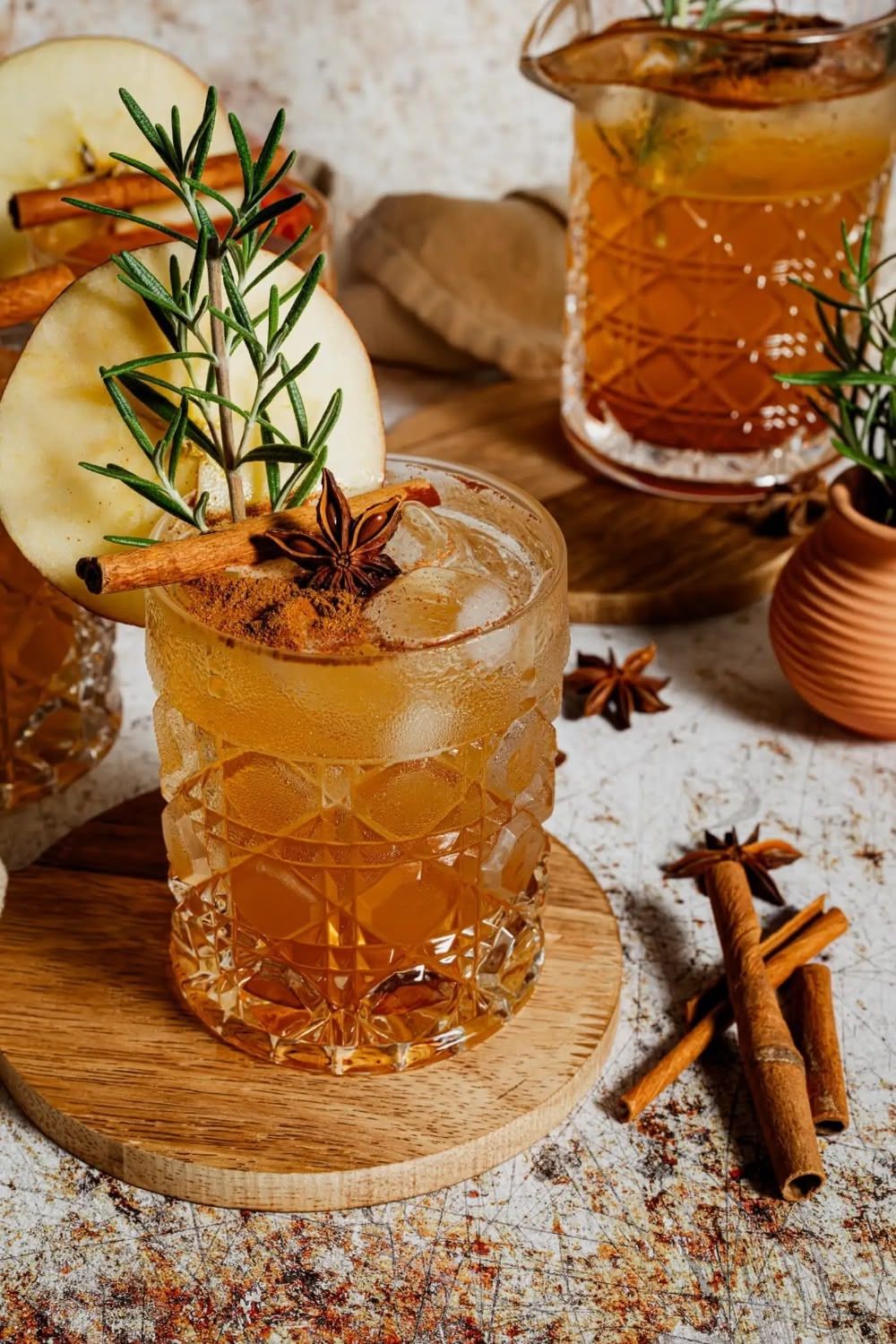 Spiced autumn mocktail garnished with apple slice, rosemary, cinnamon sticks and star anise. B. Steele Images, food and beverage photography