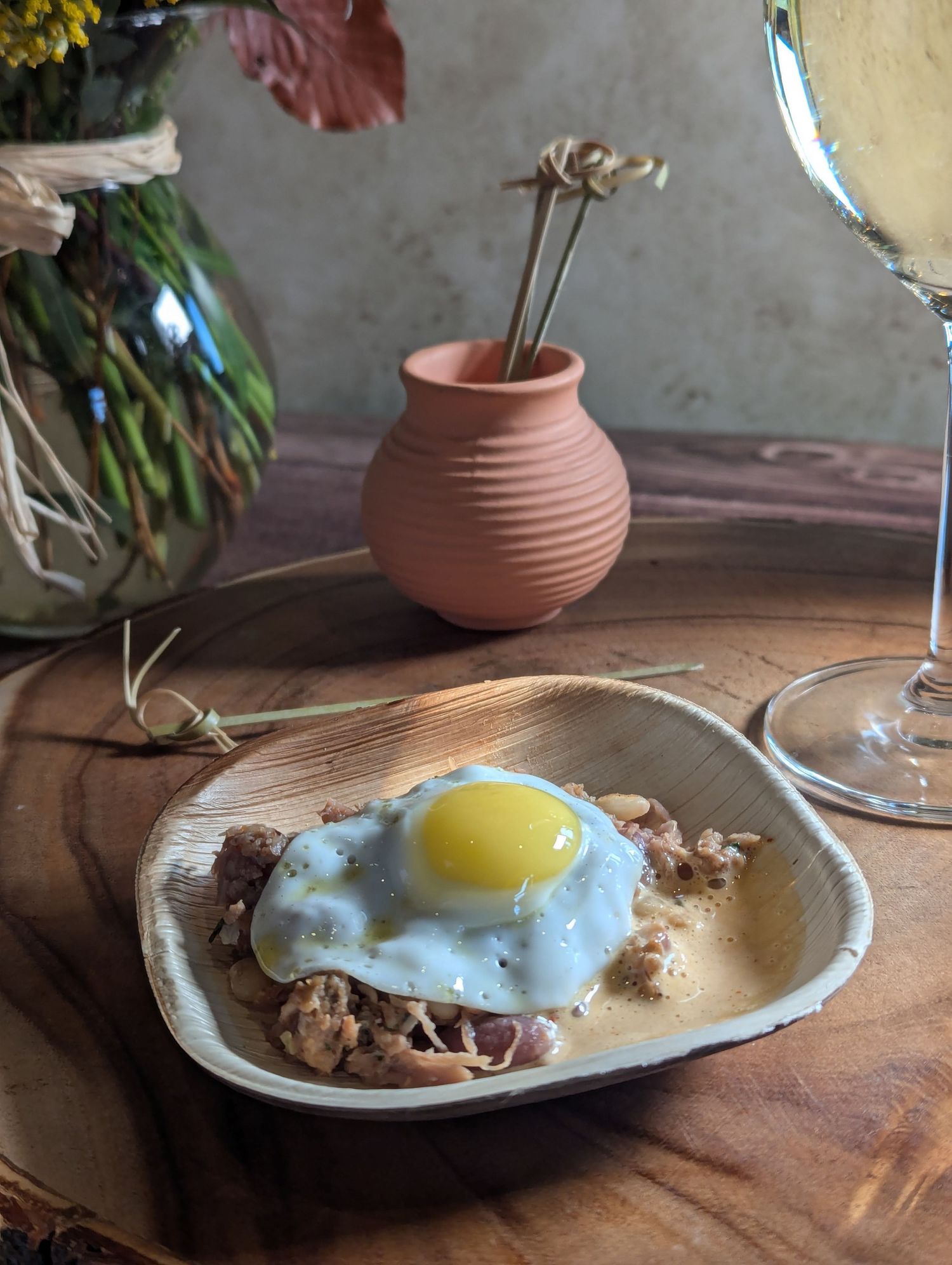 An elegant plated dish on rustic wooden surfaces, showcasing fine dining presentation in honor of Native American Heritage Month. B. Steele