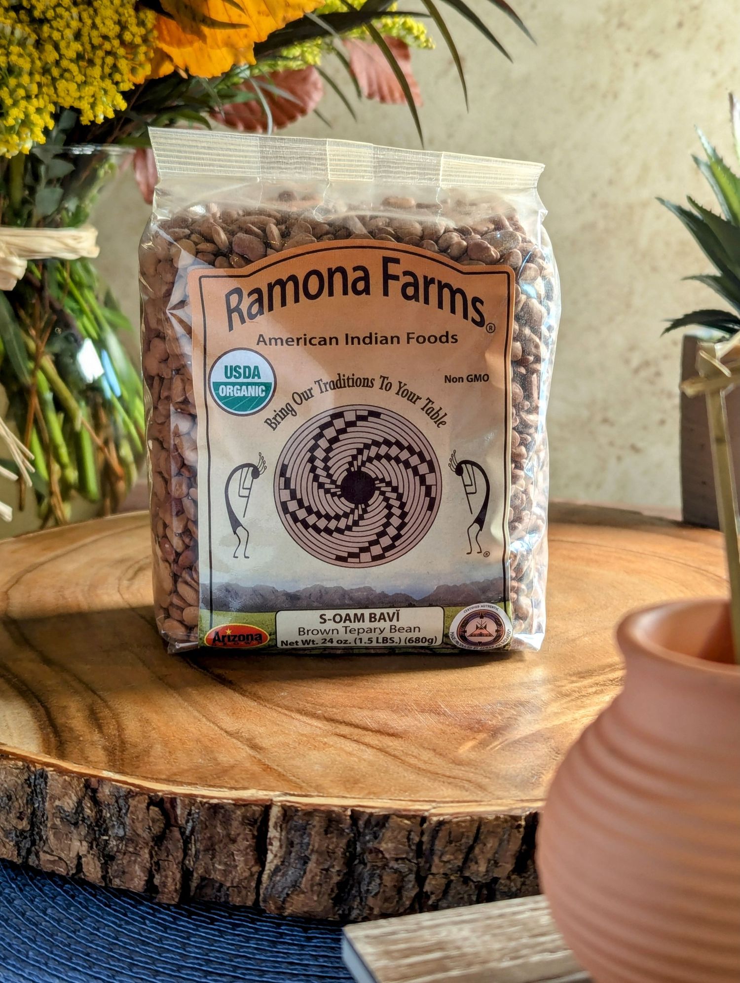 Ramona Farms organic dried beans package displayed on rustic wooden surfaces with terracotta pots in foreground. B. Steele Images