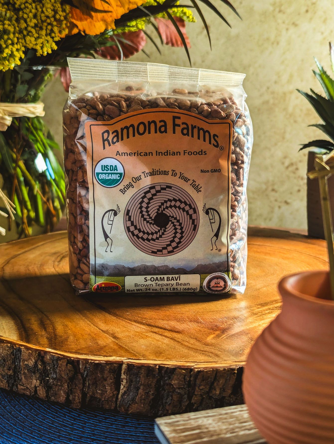 Ramona Farms organic dried beans package displayed on rustic wooden surfaces with terracotta pots in foreground. B. Steele Images