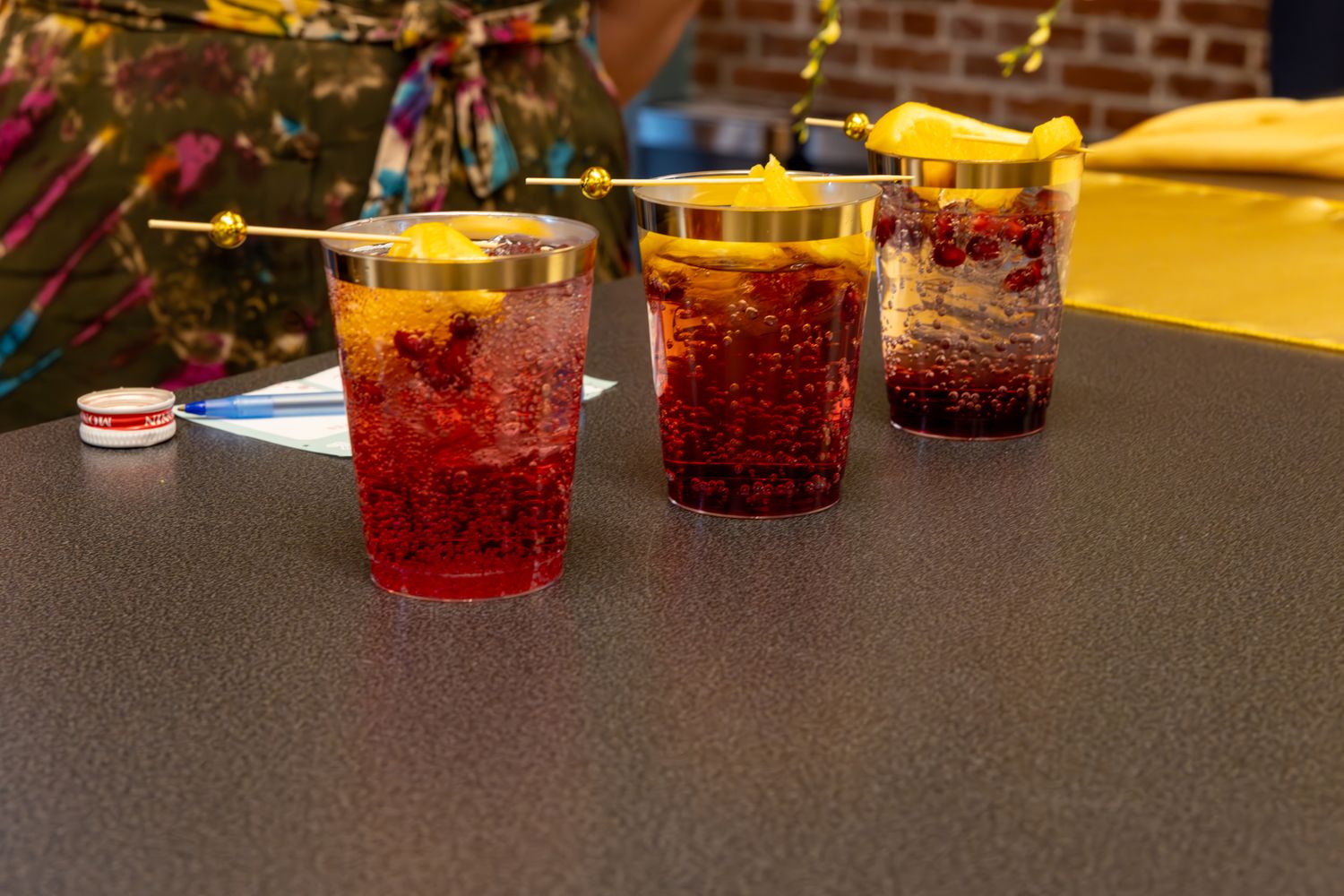 A line up of mocktails ready to serve sitting on a grey countertop at a Gala. B. Steele Images. Food & Beverage photography