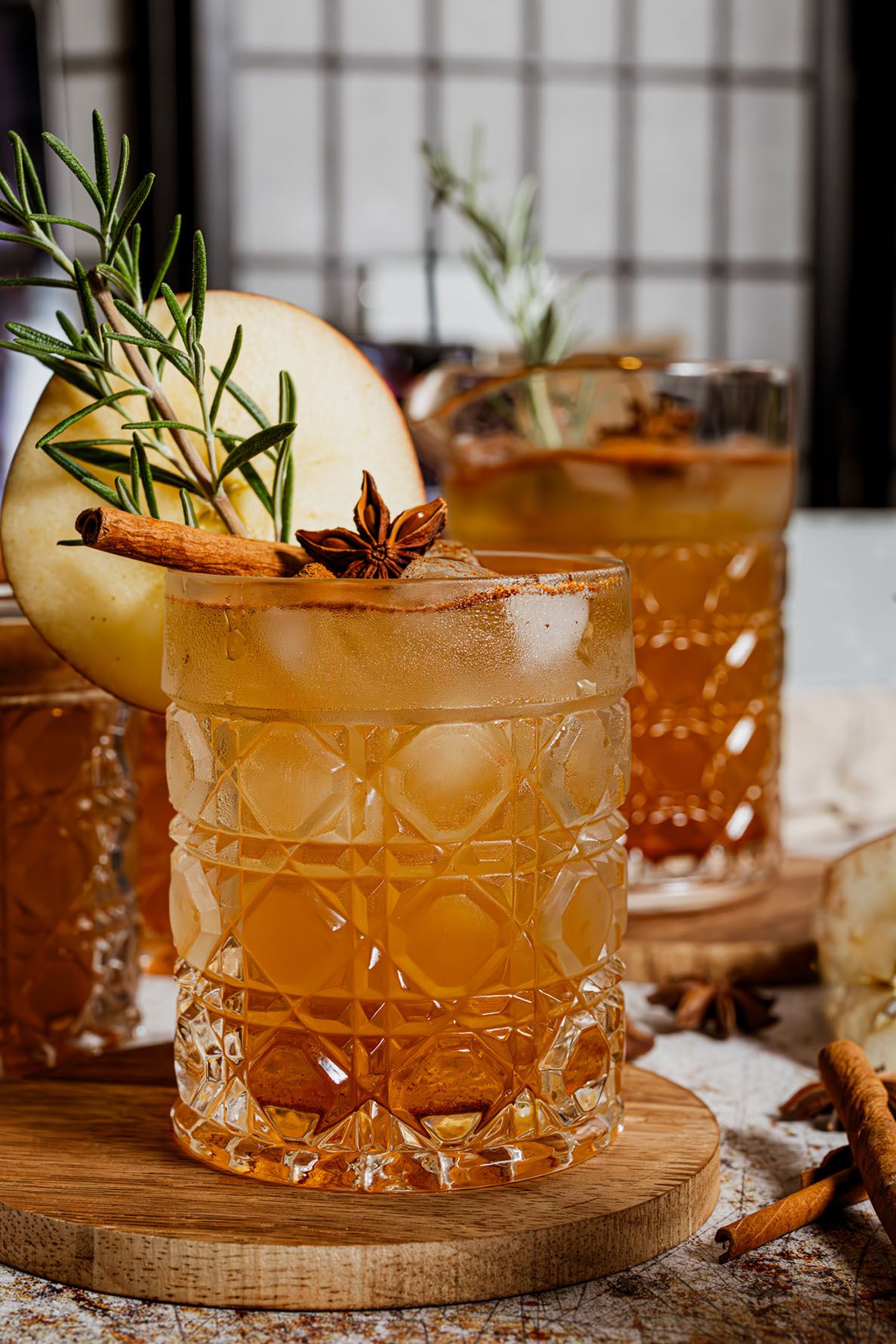 Spiced autumn mocktail garnished with apple slice, rosemary, cinnamon sticks and star anise. B. Steele Images, food and beverage photography