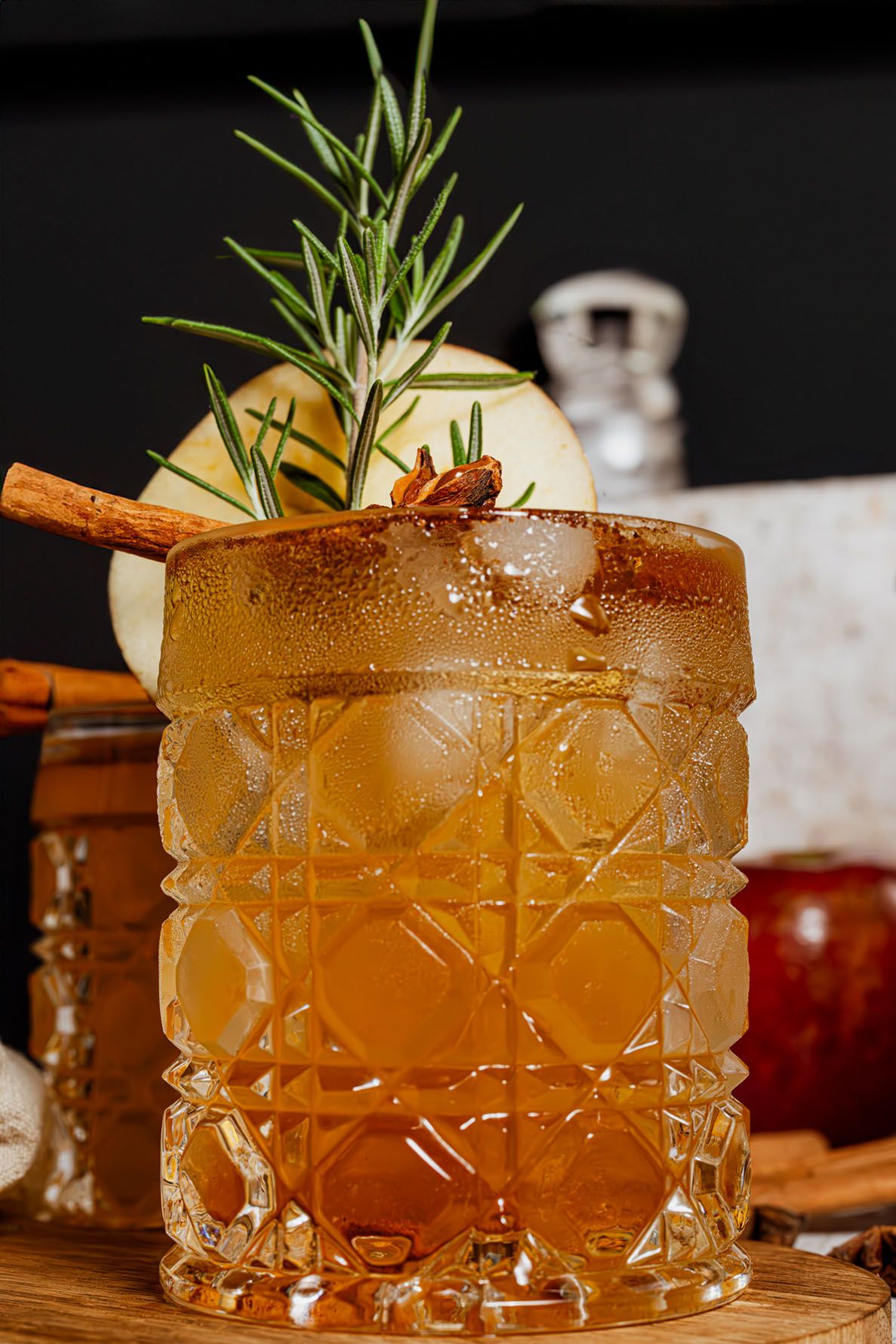 Spiced autumn mocktail garnished with apple slice, rosemary, cinnamon sticks and star anise. B. Steele Images, food and beverage photography
