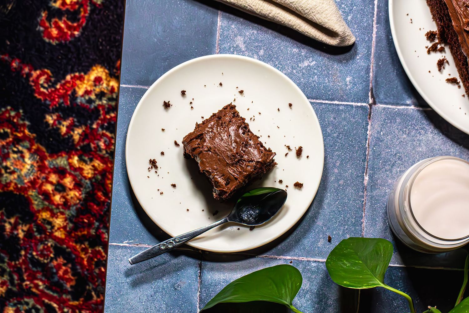 Beautiful chocolate cake slices on a white white in moody scene set for two. Food and beverage photography, B. Steele Images.