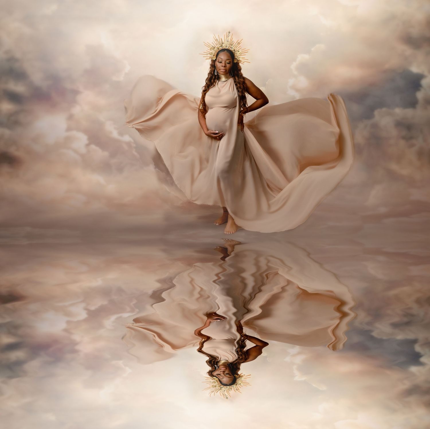 Ethereal maternity photos with flowing fabric against dramatic cloudy sky background.