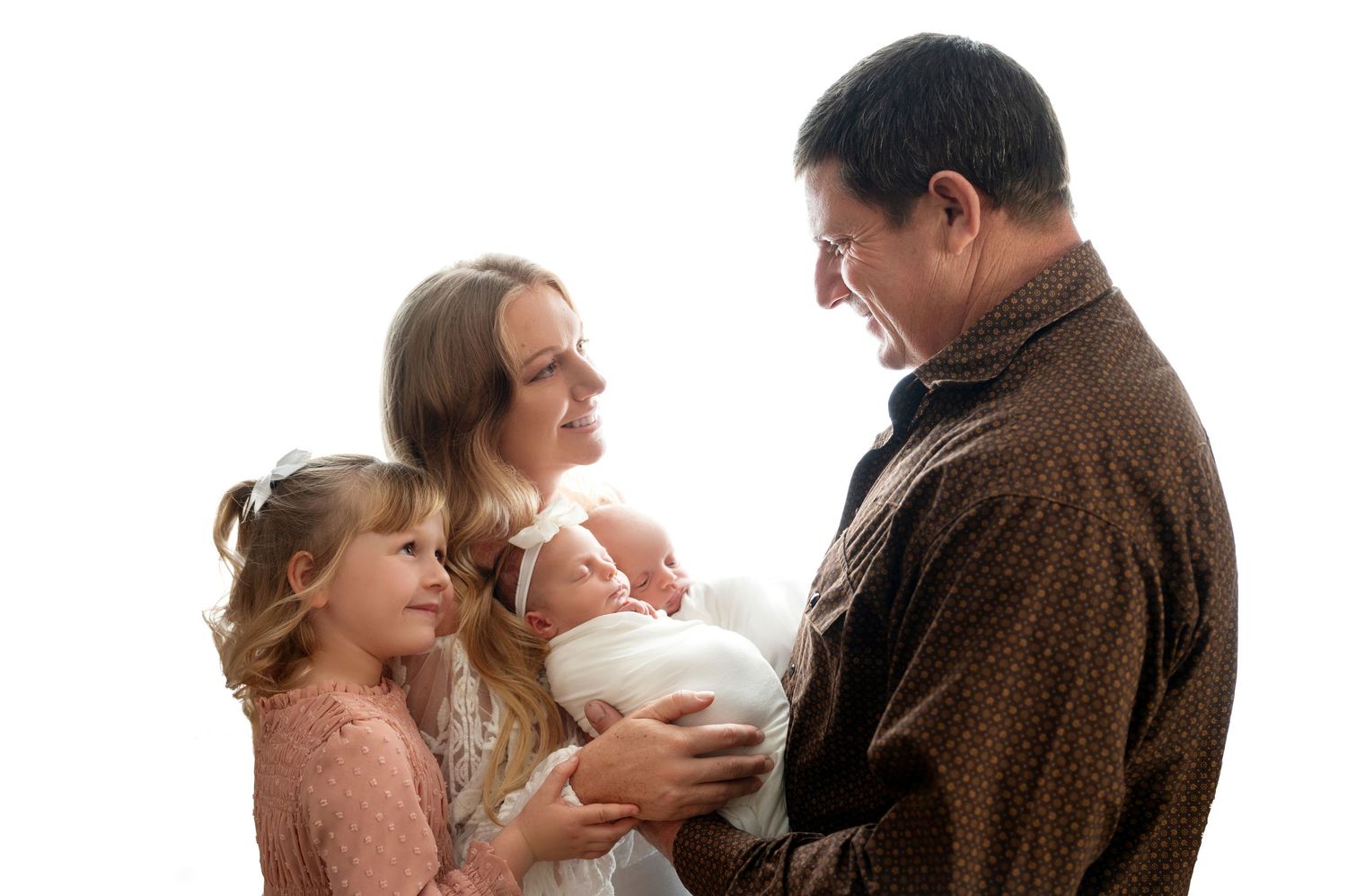 Family photo session with soft lighting and neutral tones.