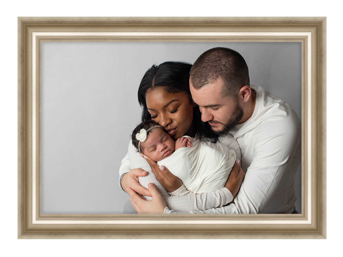 A tender family moment captured in a gold frame against a neutral background.