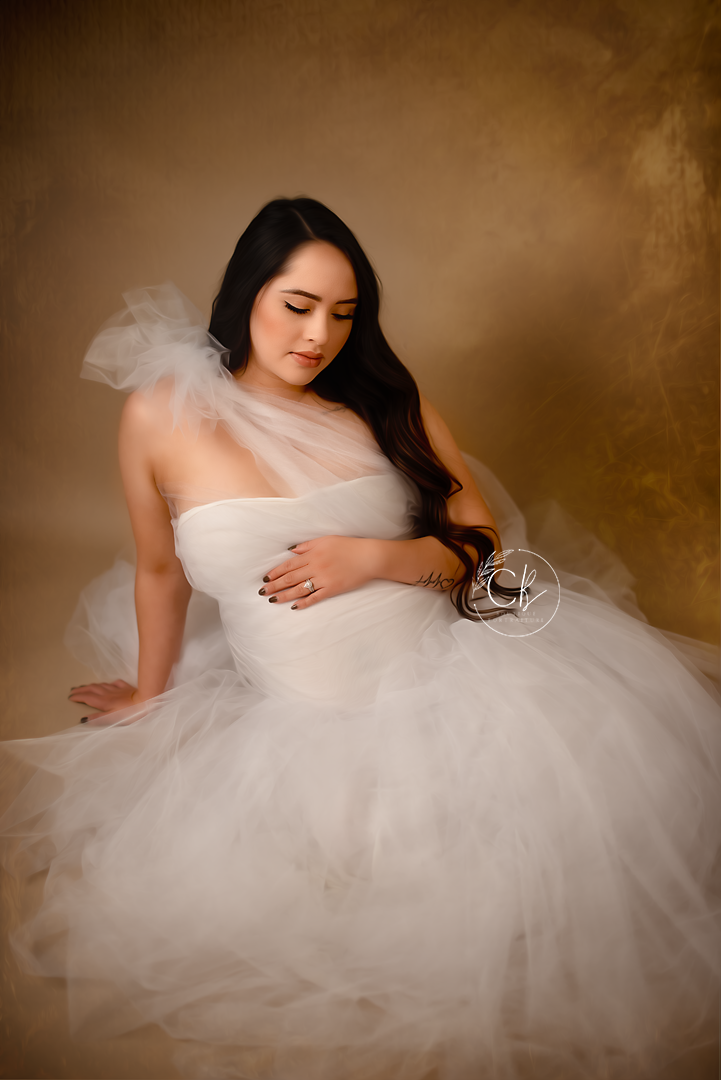 Elegant maternity portrait featuring a white tulle gown in soft sepia tones. Fresno Maternity Photographer