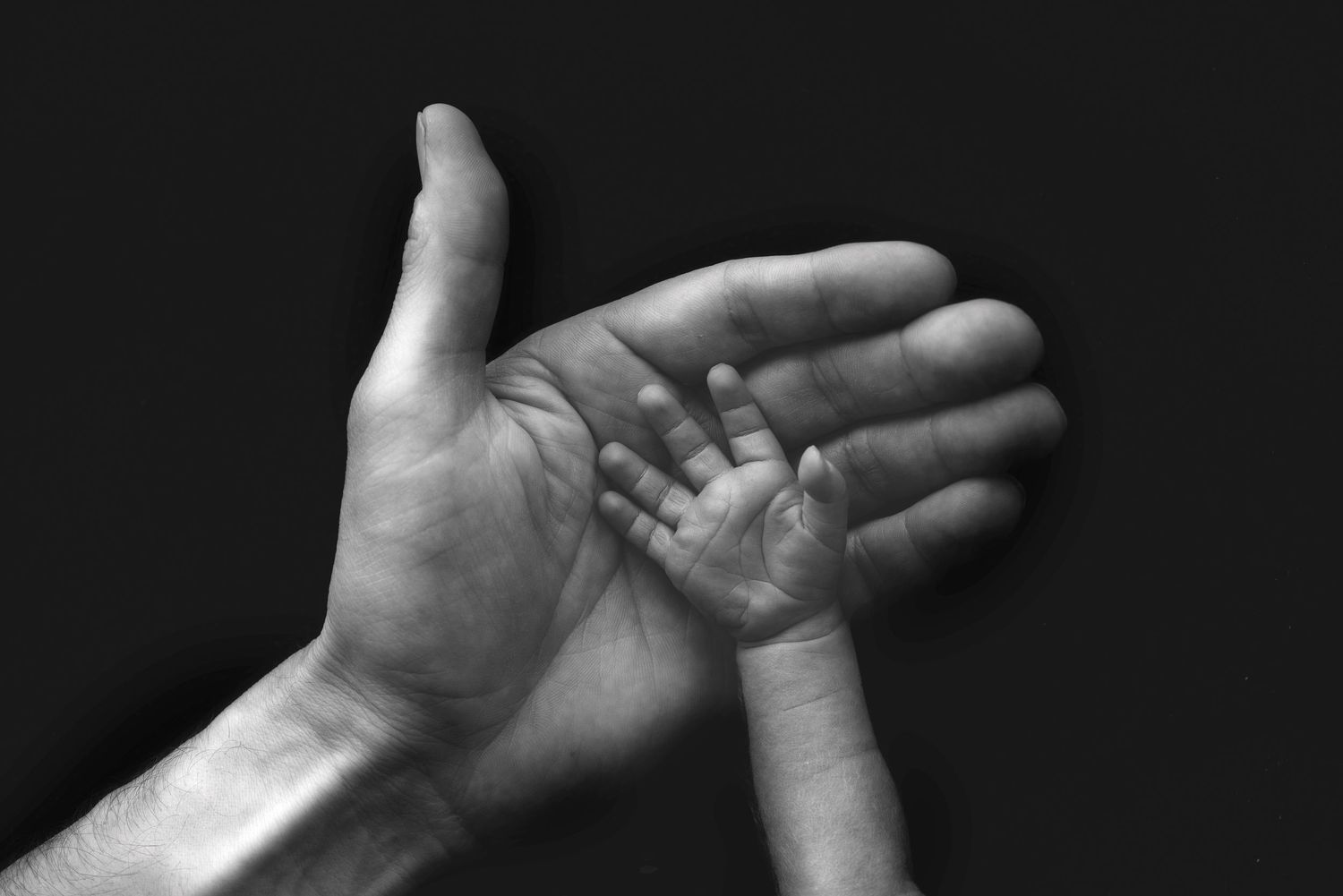 A series of black and white photographs showing different hand gestures and positions against a dark background.