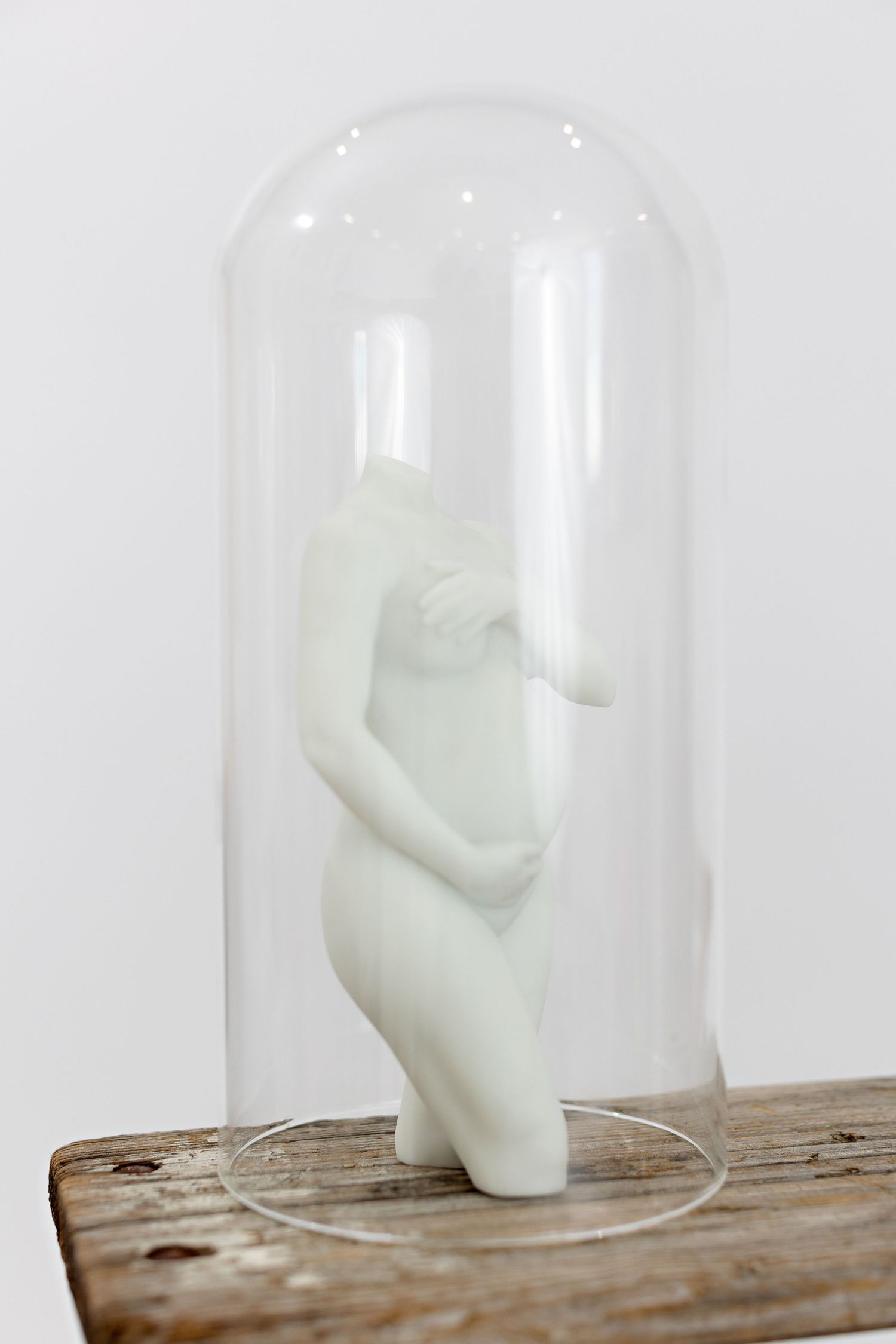 White ceramic pregnancy sculpture displayed under a glass bell jar cloche on a rustic wooden base. 3D Pregnancy Sculpture Fresno, CA