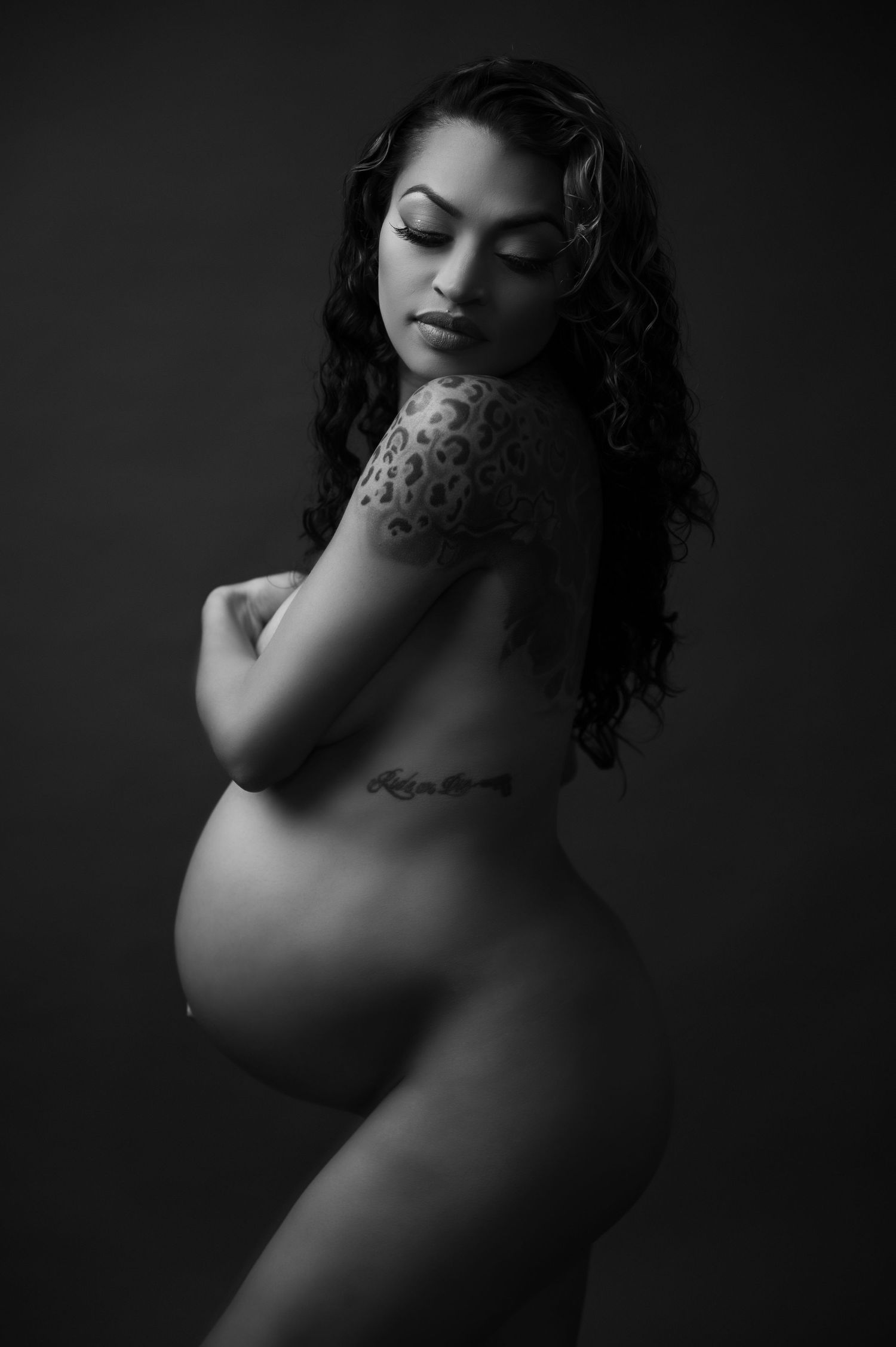 Dramatic black and white boudoir portraits with moody lighting and shadows.