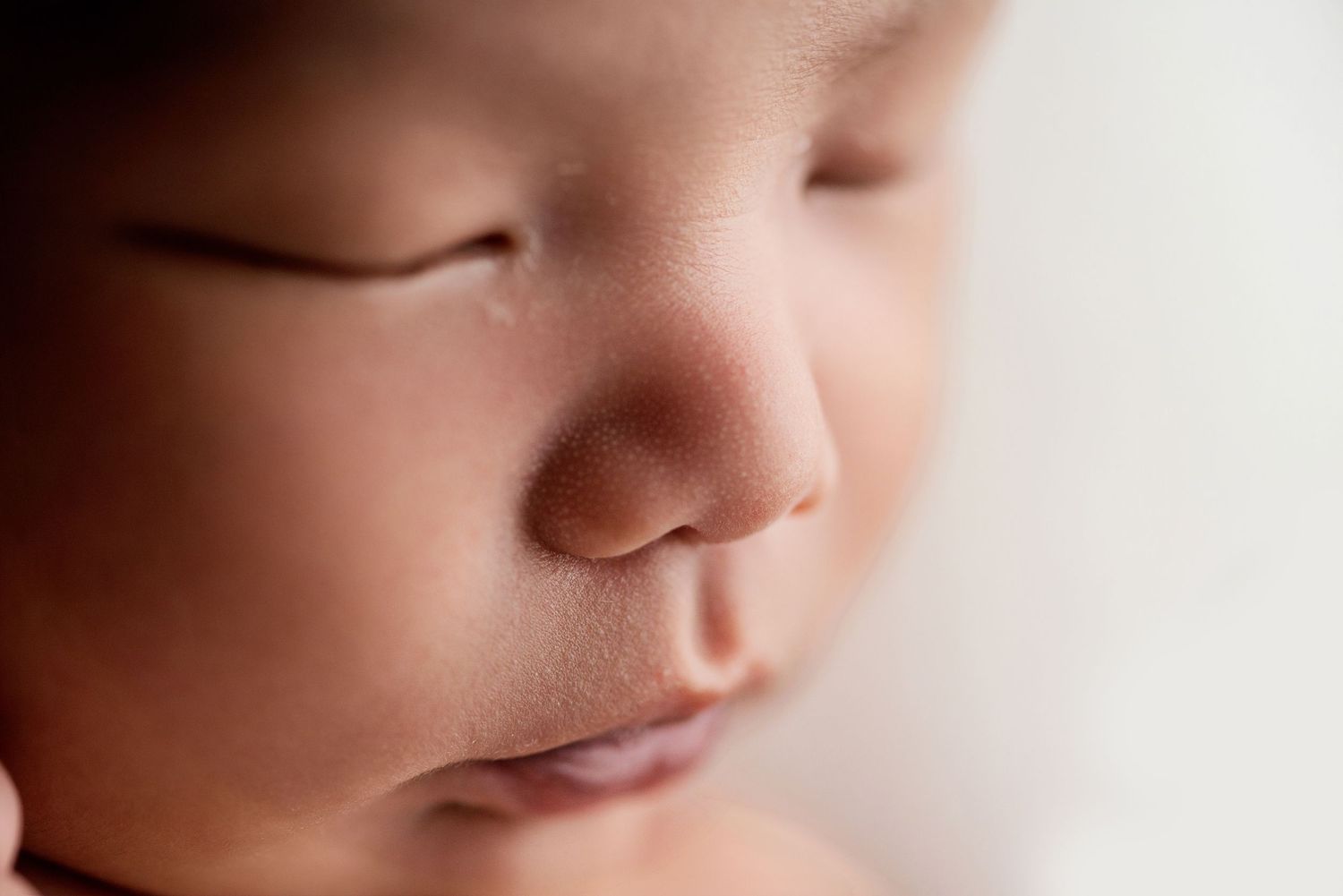 Close-up macro shots of delicate newborn facial features in soft lighting. Hanford Newborn Photographer