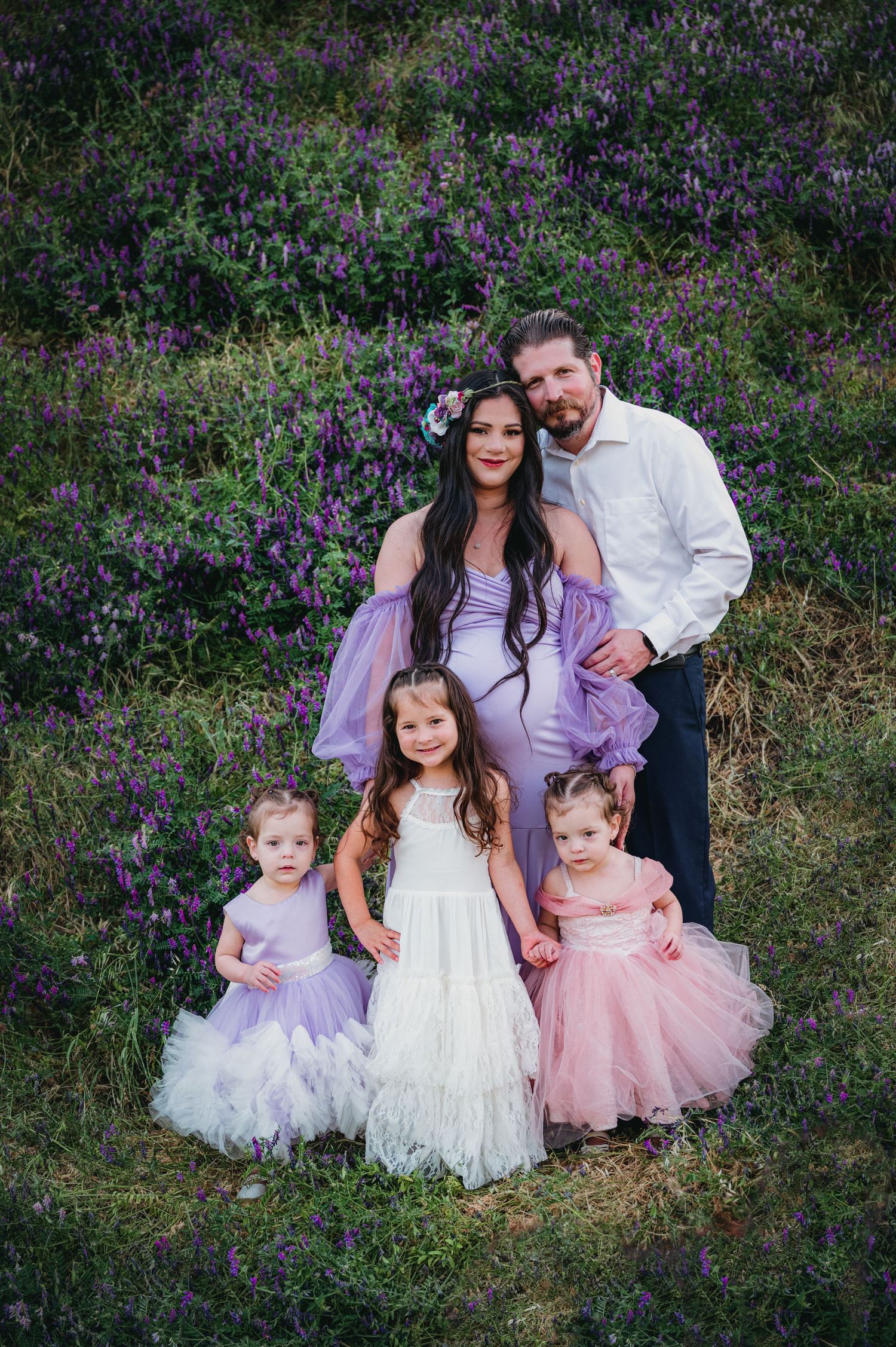 Family portrait with children in formal wear against backdrop of purple flowers. Fresno Family Photography
