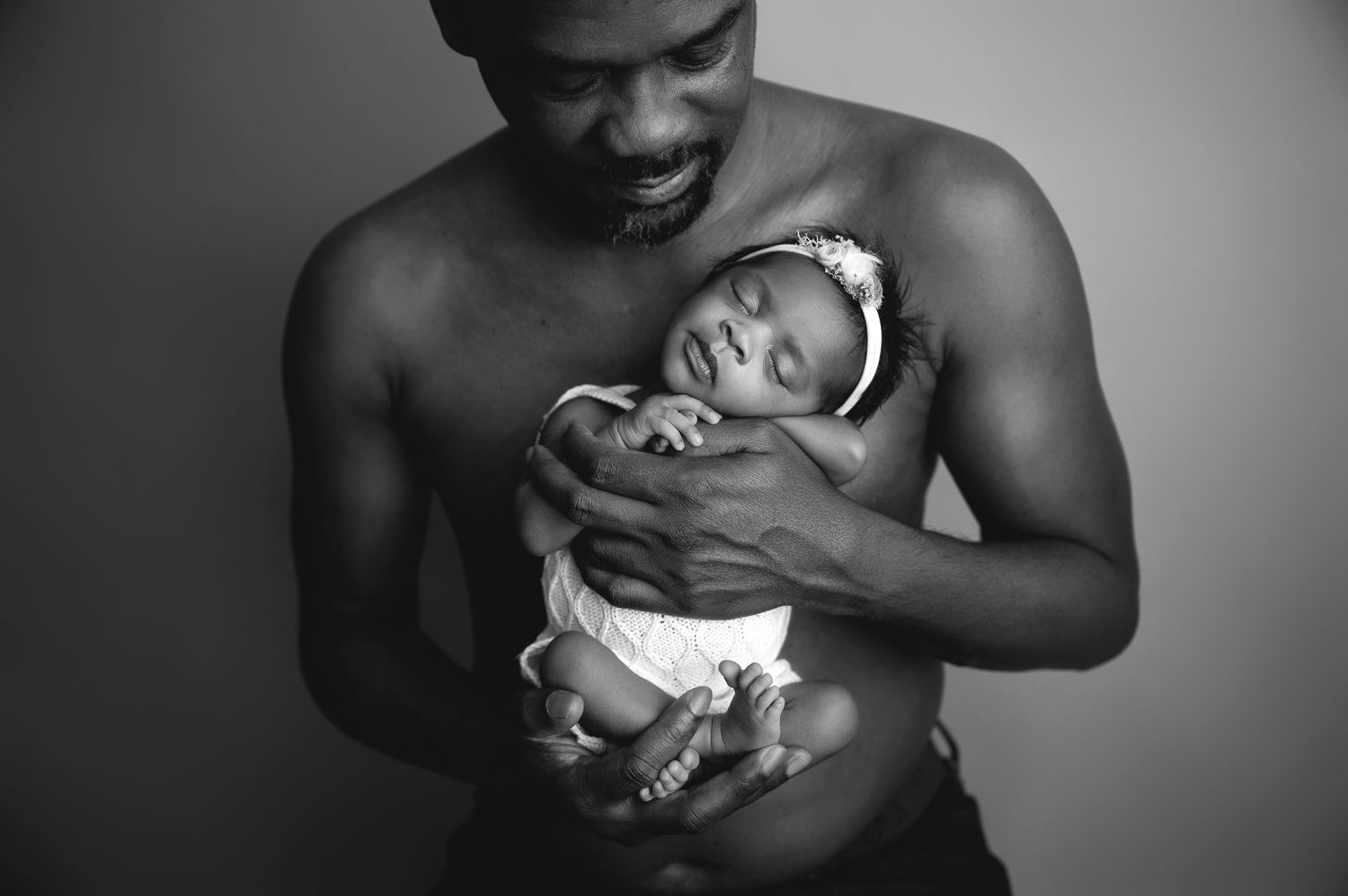 Black and white portrait series showing tender moments between parent and newborn.