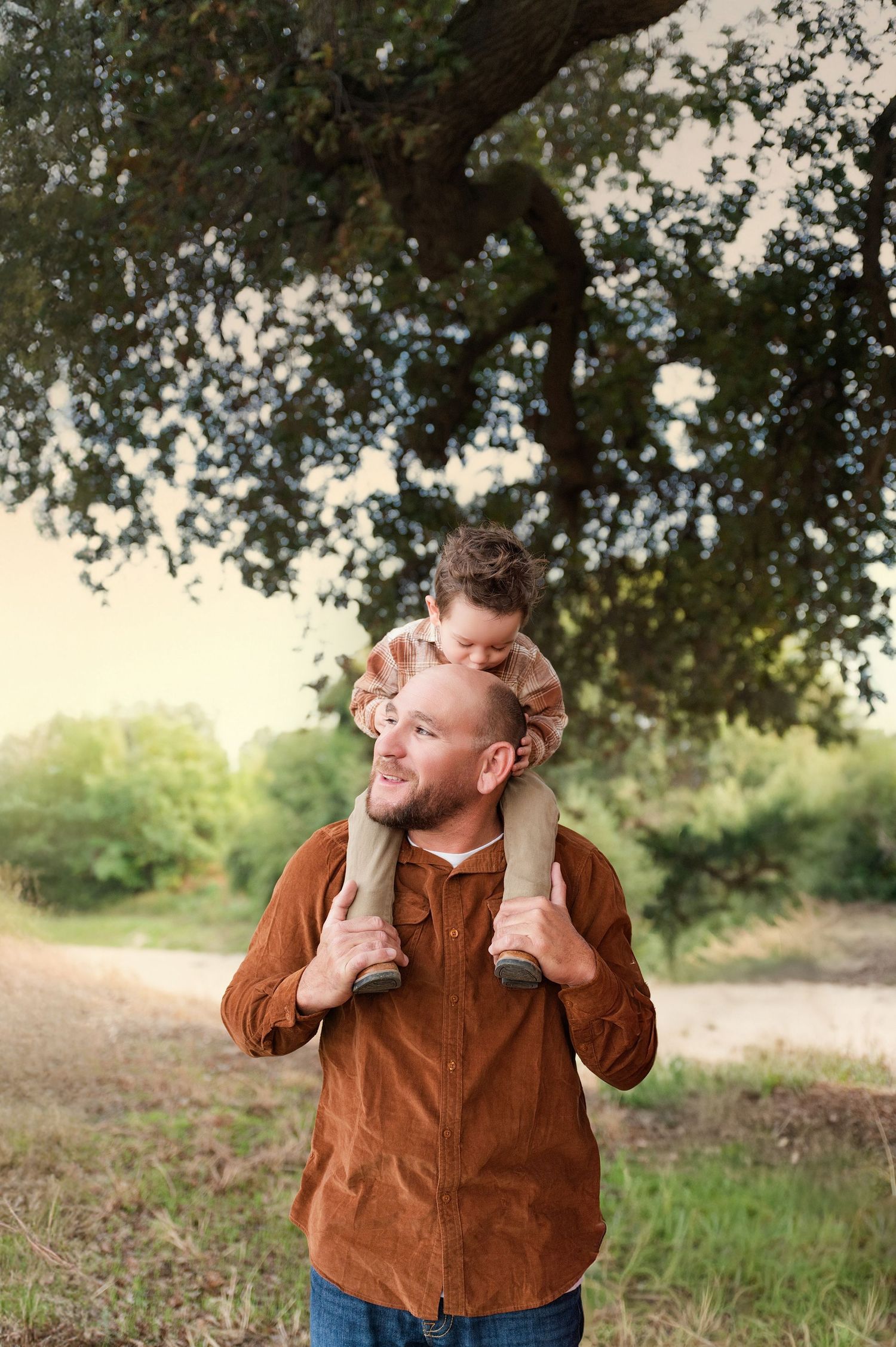 Playful expressions and poses under tree branches during a casual outdoor photo session. Hanford Family Photographer