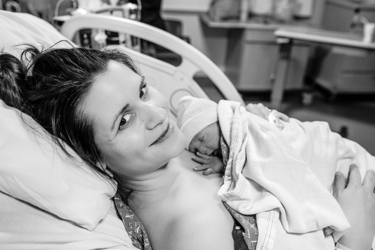 Black and white photo of a patient resting in a hospital bed.