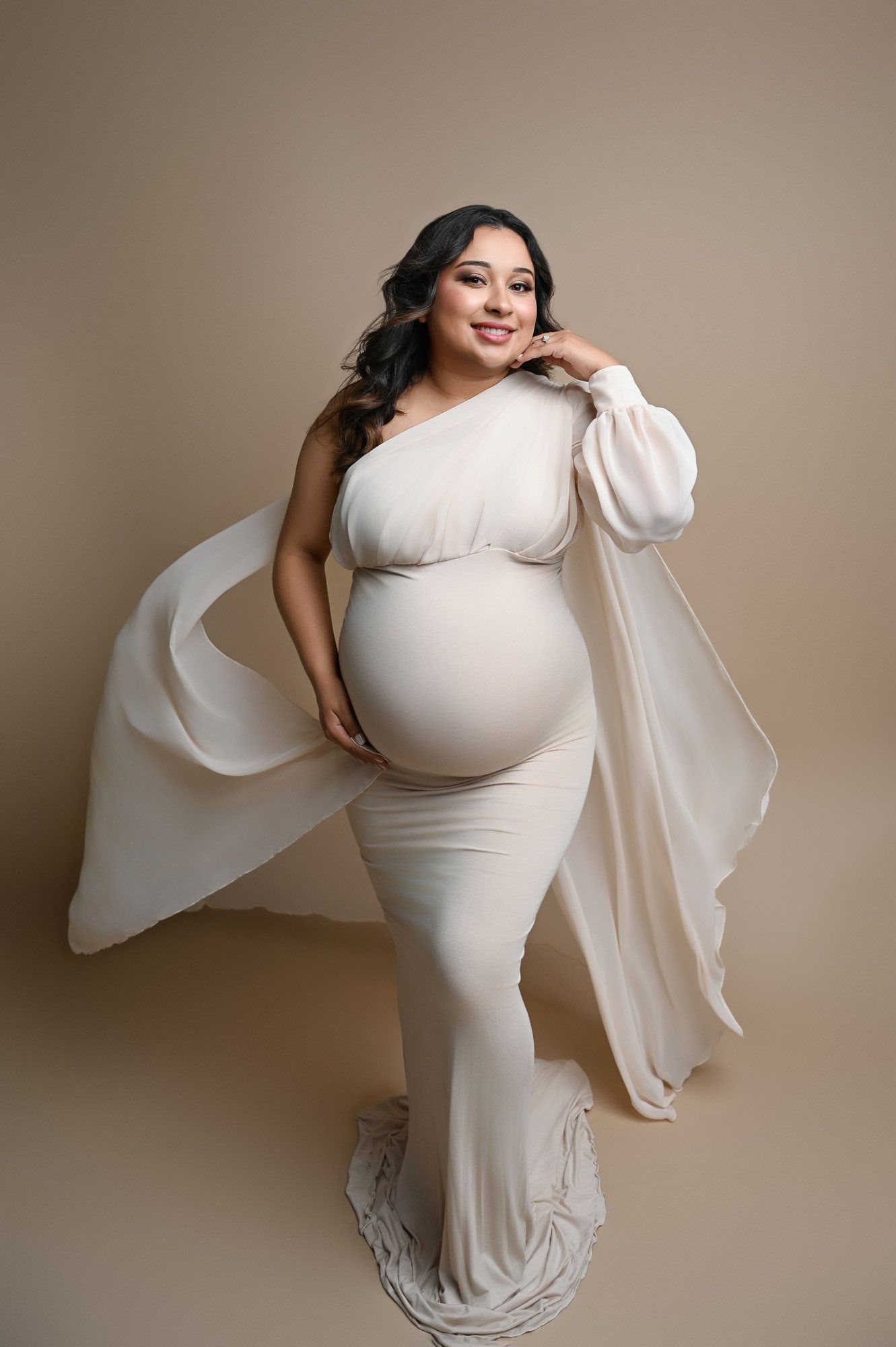 Maternity photoshoot sequence showing a woman in a flowing white dress against a neutral backdrop.