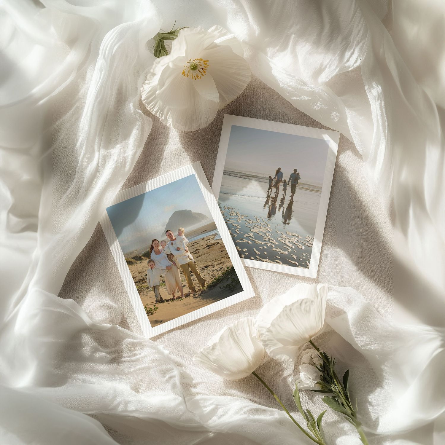 Two family photos on white silk fabric with white flowers, one at beach and one at scenic outdoor location.