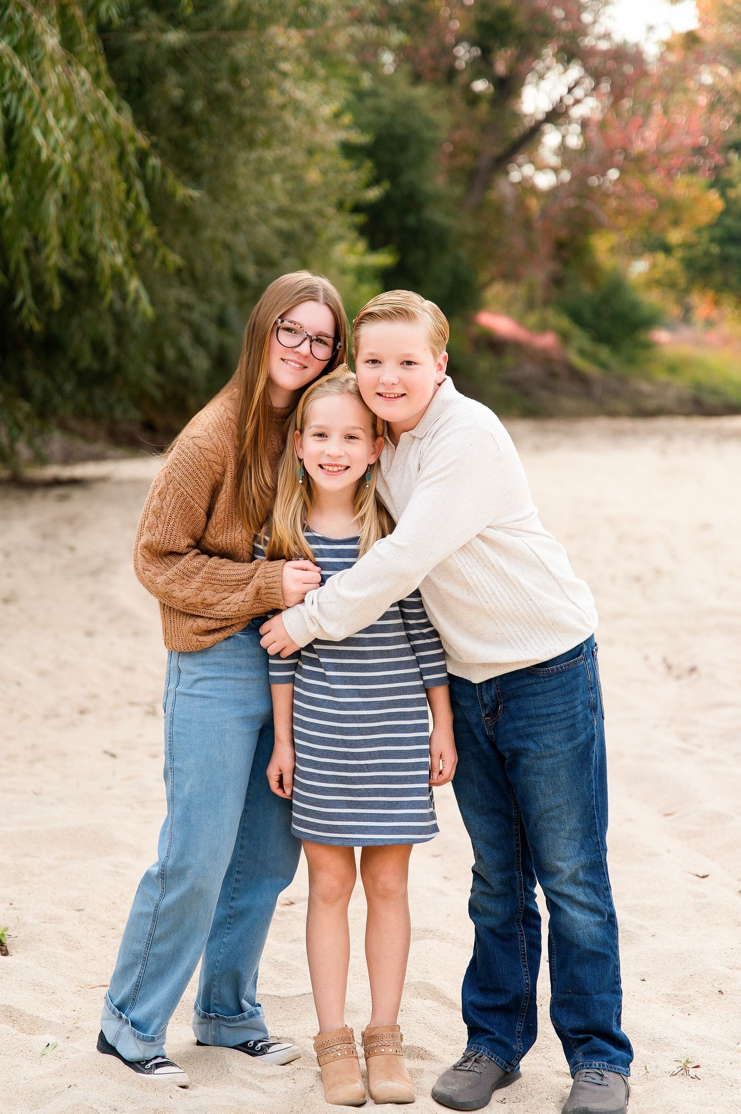 Casual family photos outdoors with sandy beach and autumn foliage. Hanford Family Photographer