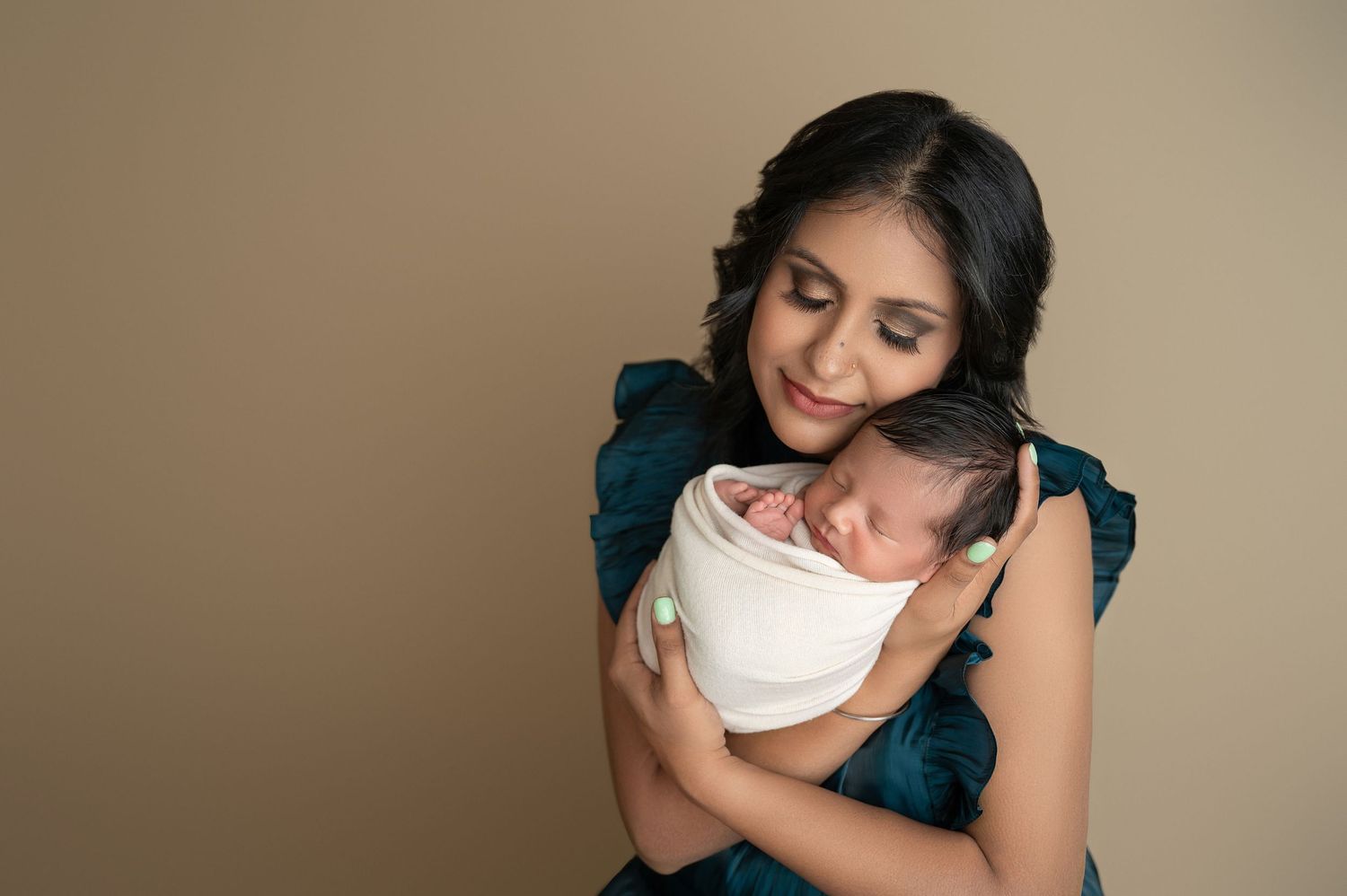 Tender family moments captured in warm tones with navy blue clothing.