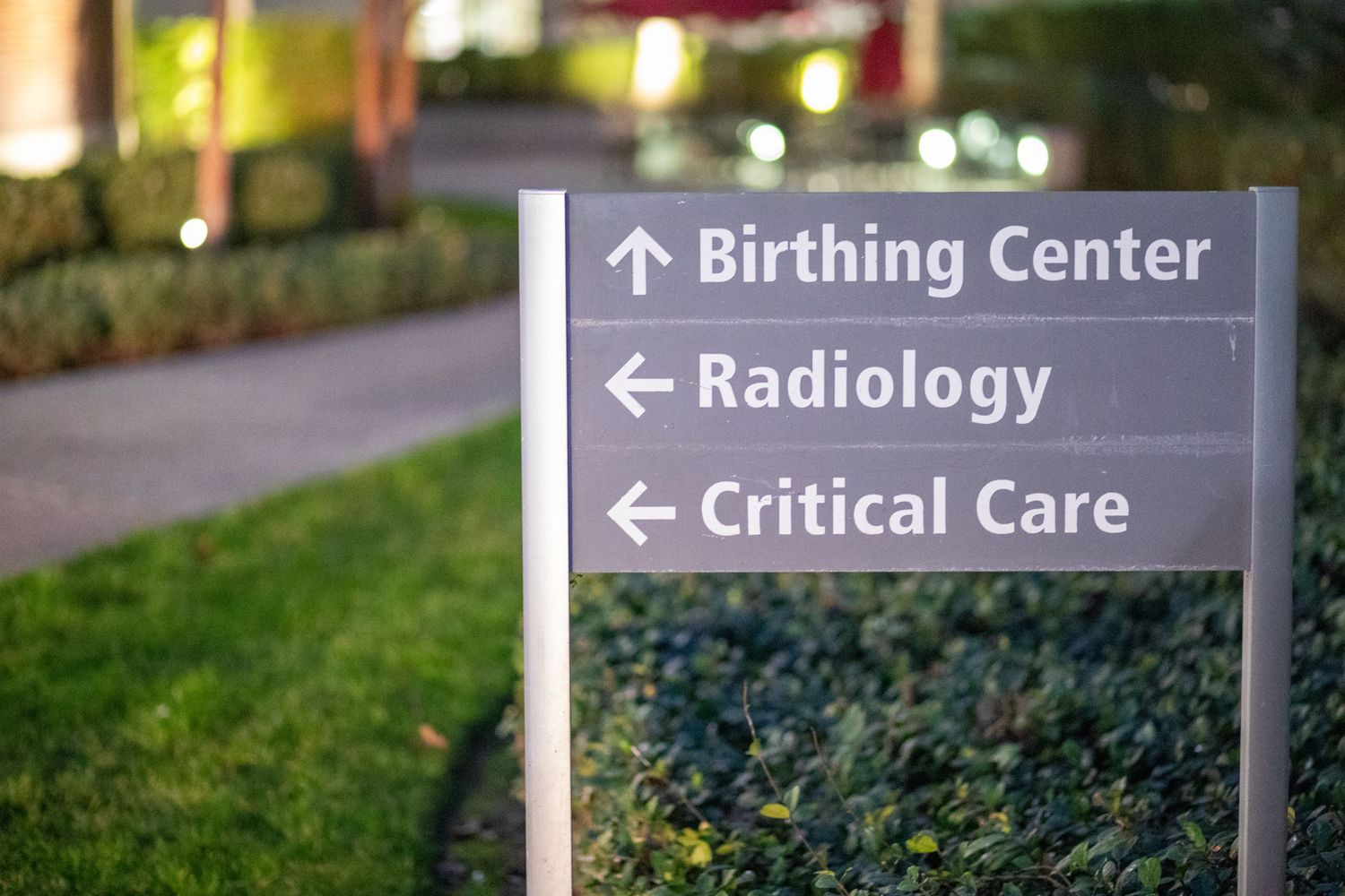 Hospital directional sign showing arrows to Birthing Center, Radiology and Critical Care departments.