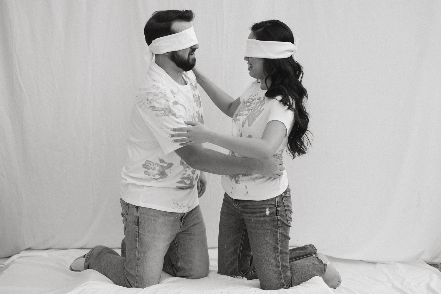 A series of black and white photos showing two people in white shirts embracing and dancing together.