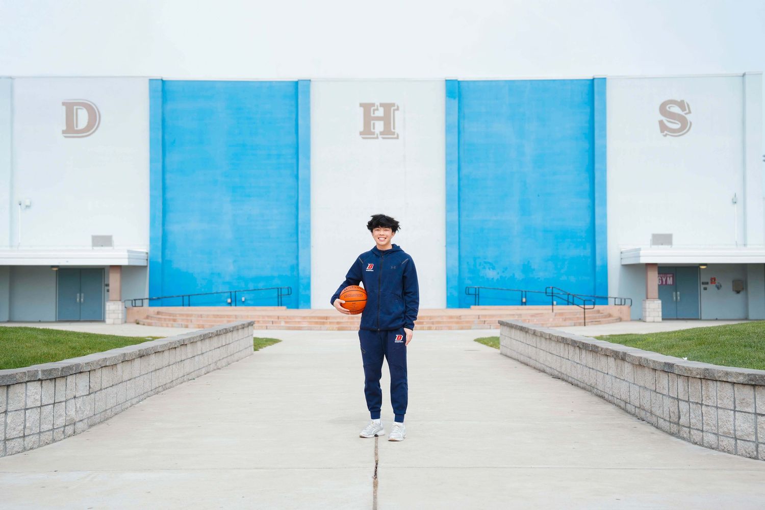 A series of minimalist architectural photos showing blue doors and concrete walls in an urban setting.
