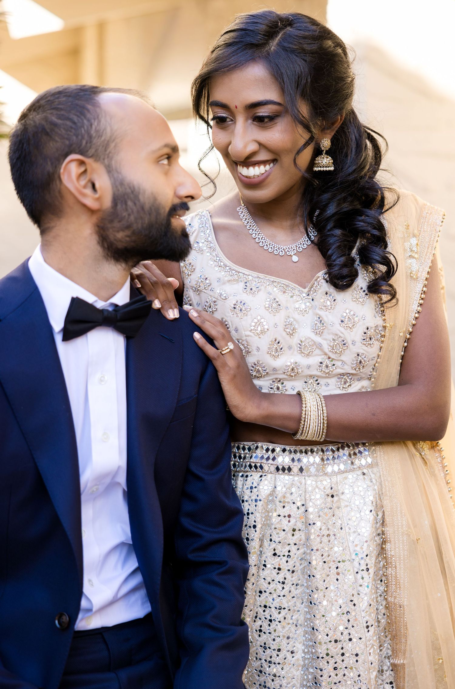 Couple in formal attire shares romantic moments in sequence of candid portraits.