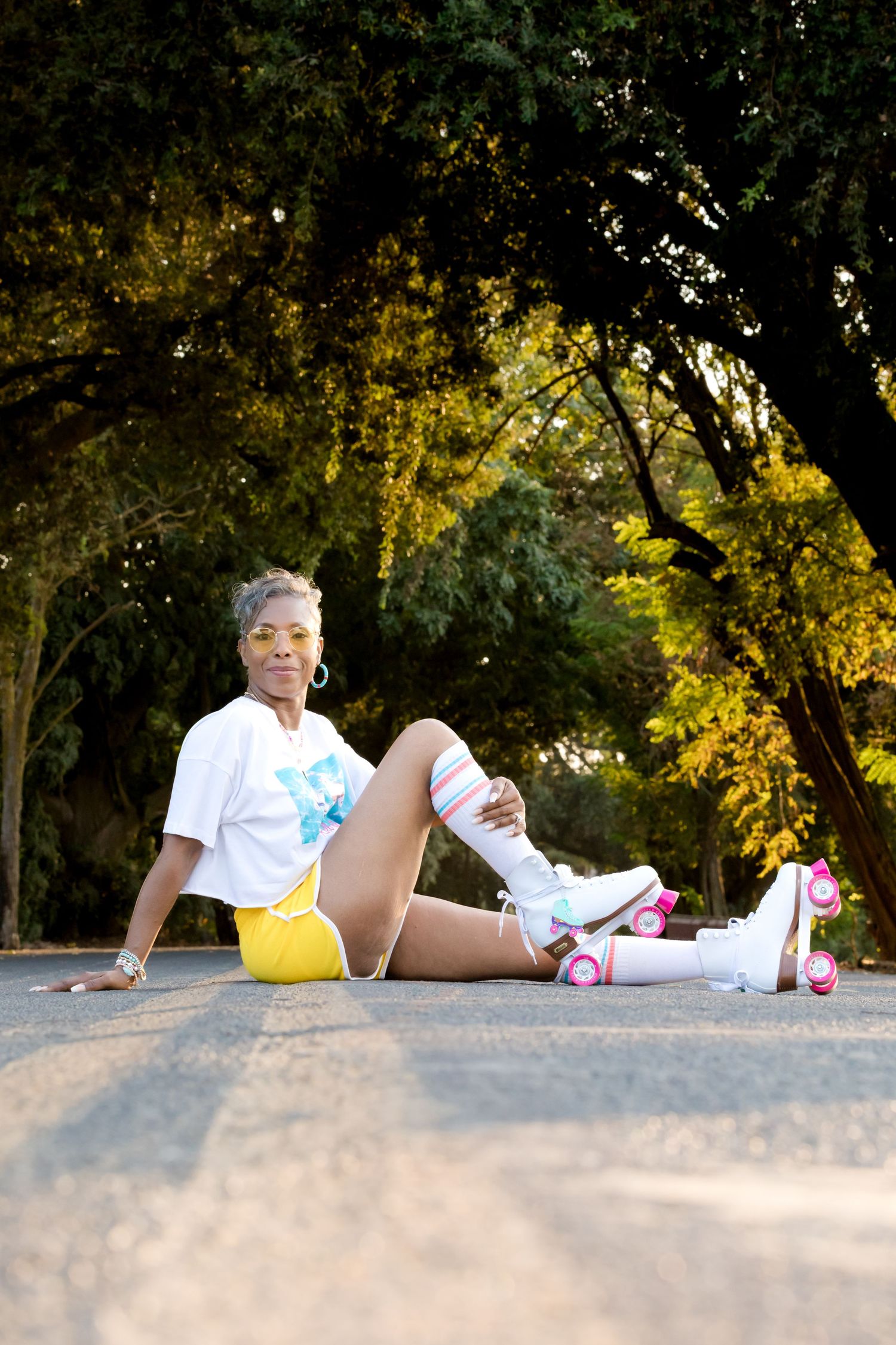 A sequence of images showing a person lying on the ground in a park setting with autumn trees in the background.