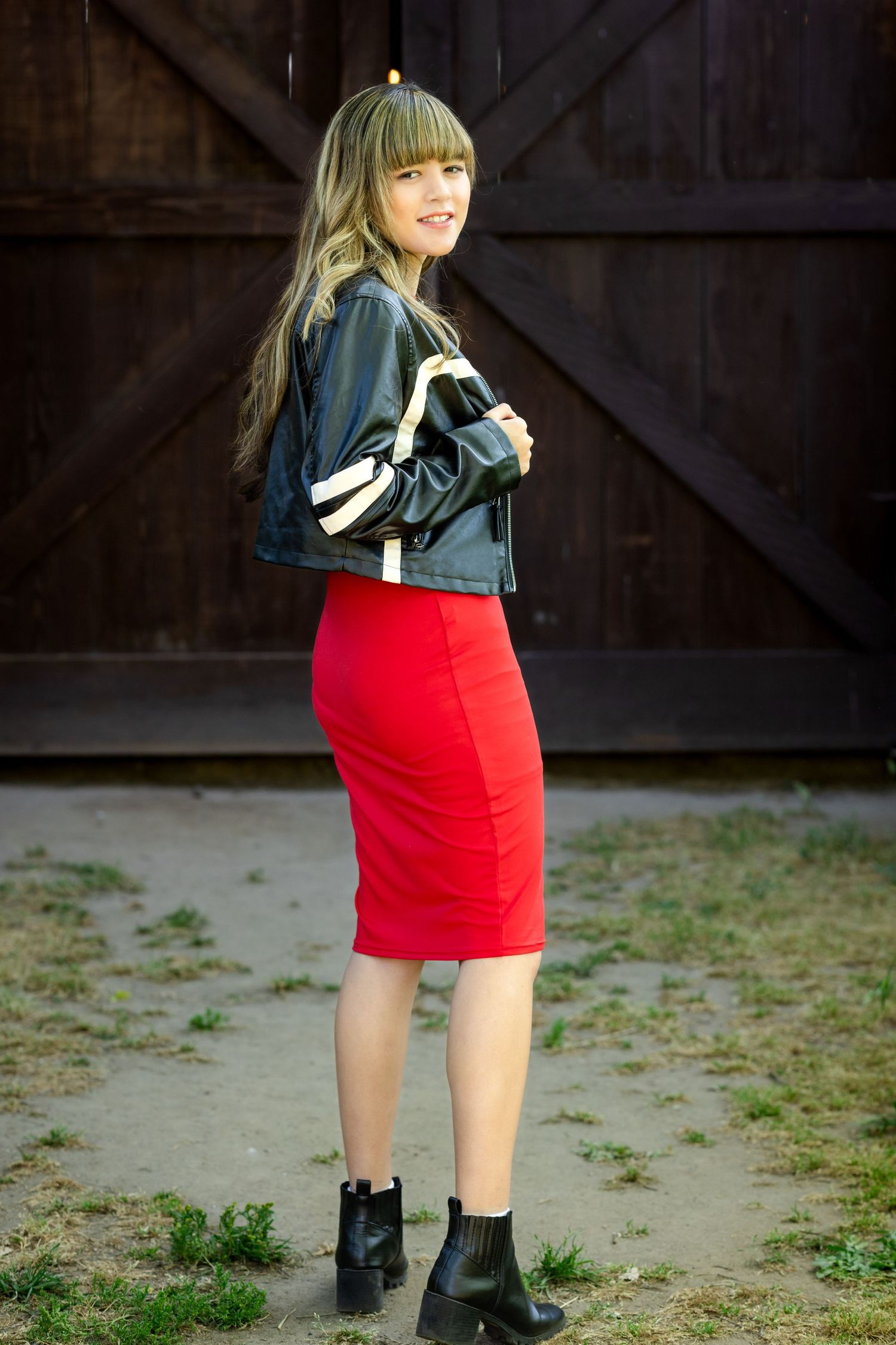 Fashion photo sequence featuring red skirt and black jacket against rustic barn backdrop.