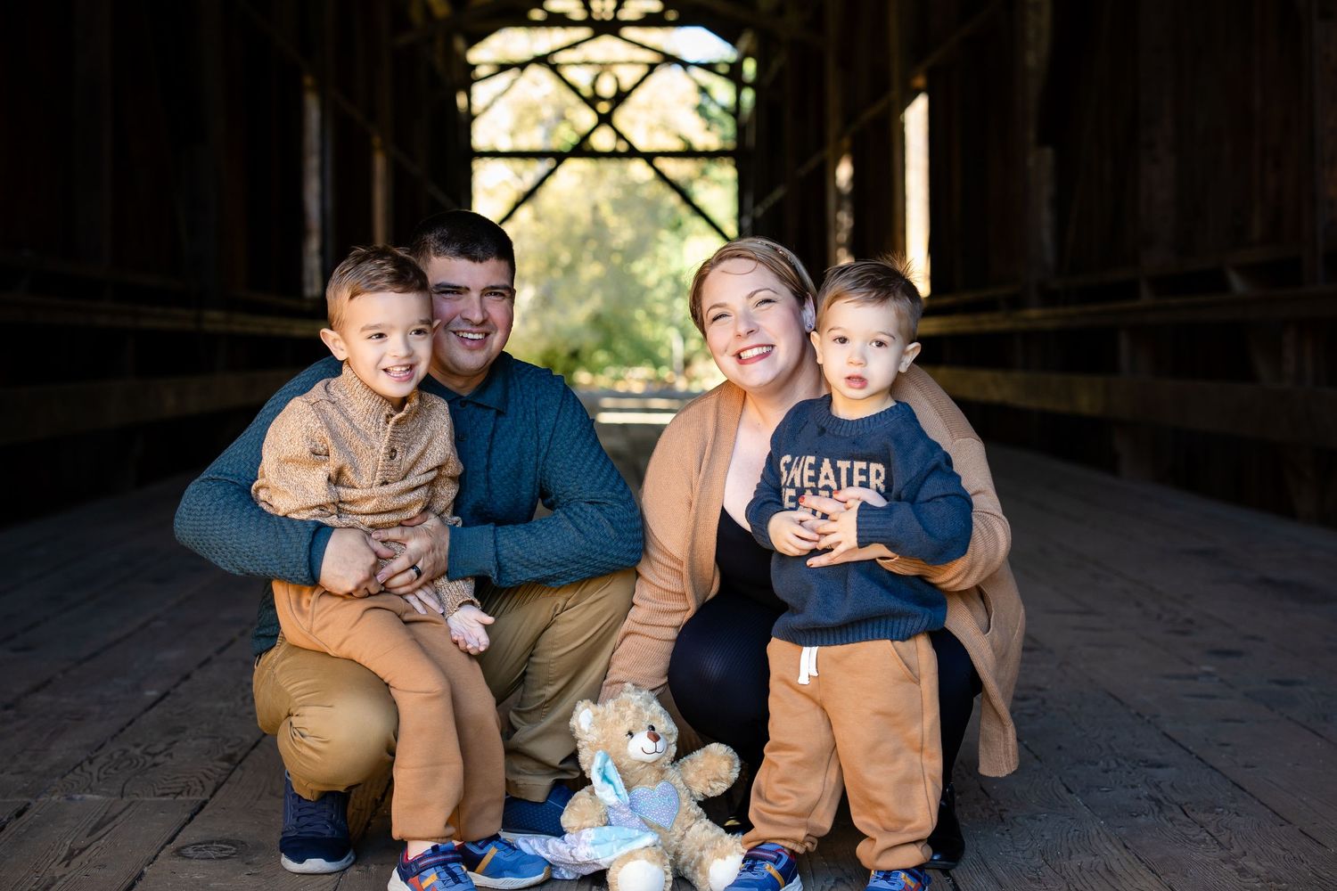 Family gathering inside a rustic barn with natural light streaming through.