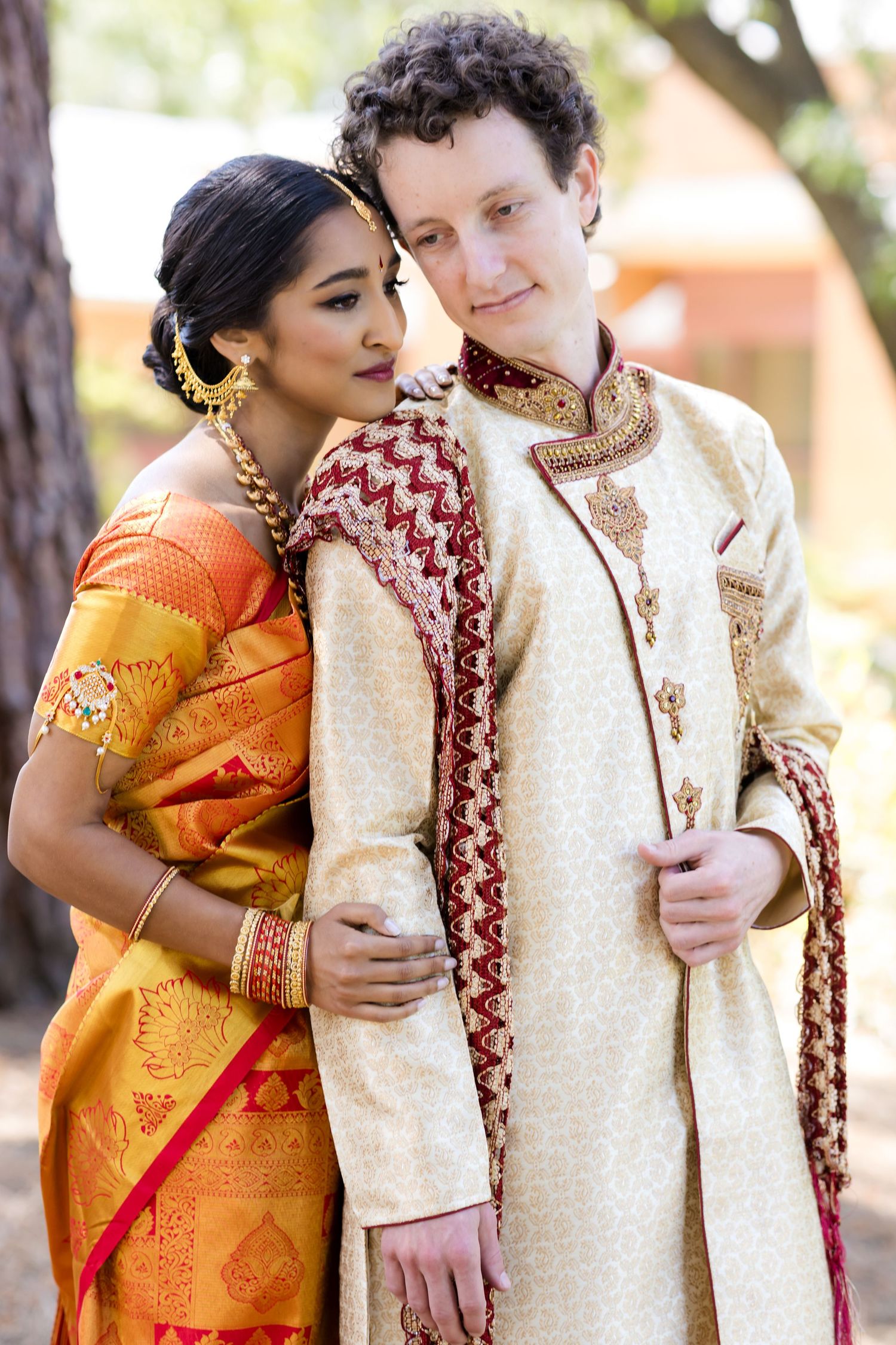 Wedding couple in traditional Indian attire sharing intimate moments in outdoor photo sequence.