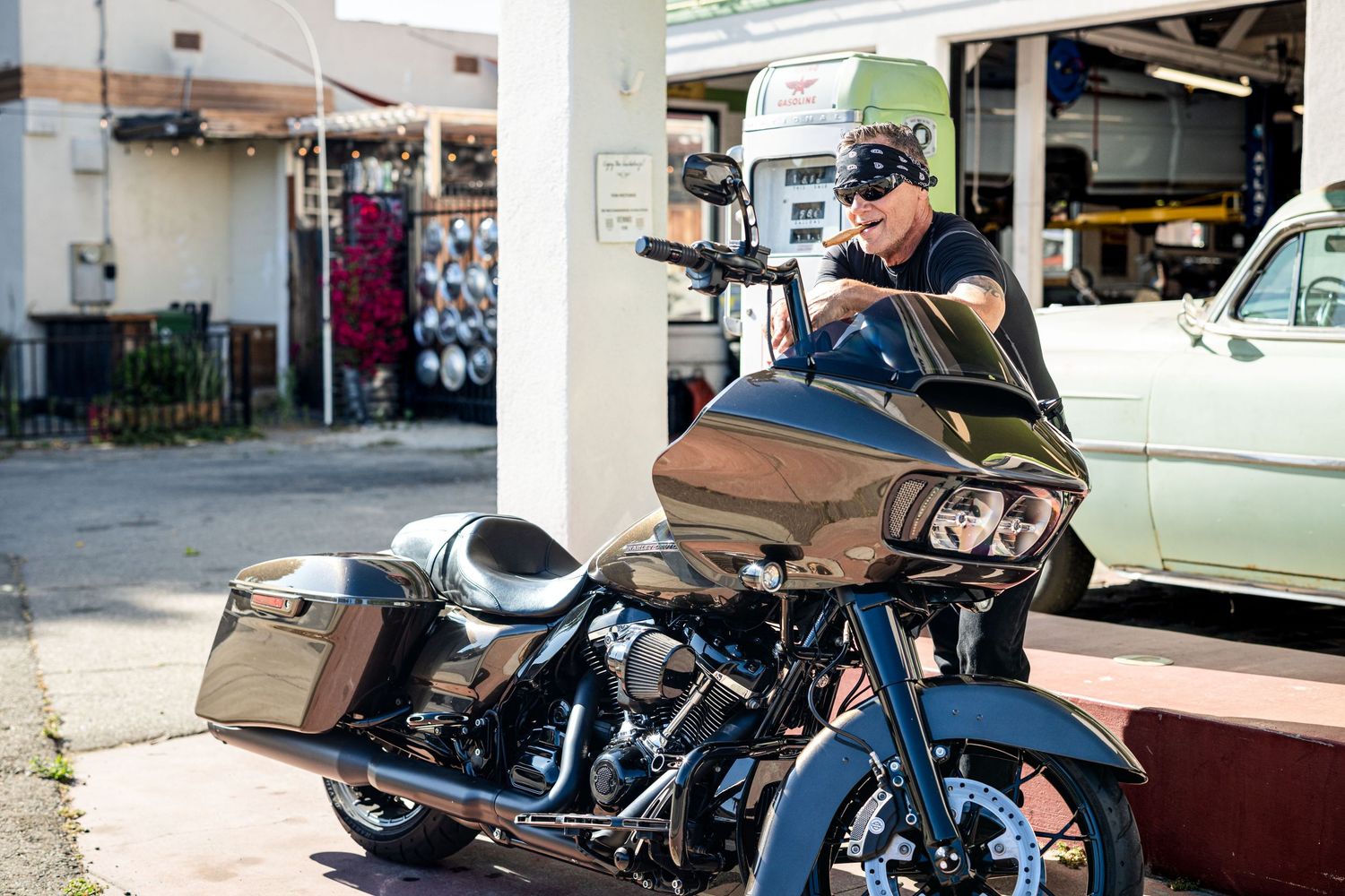 A row of custom motorcycles parked in front of a building showing various styles and designs.