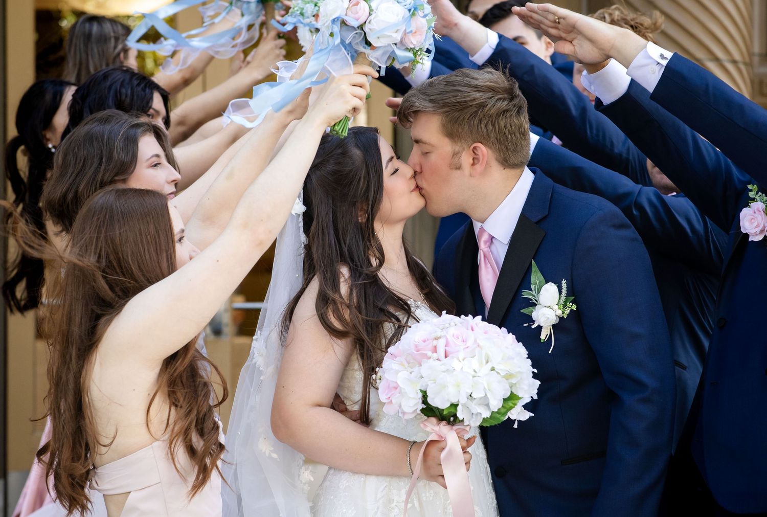 A romantic wedding photo collage showing multiple shots of a couple in navy and white sharing intimate moments together.