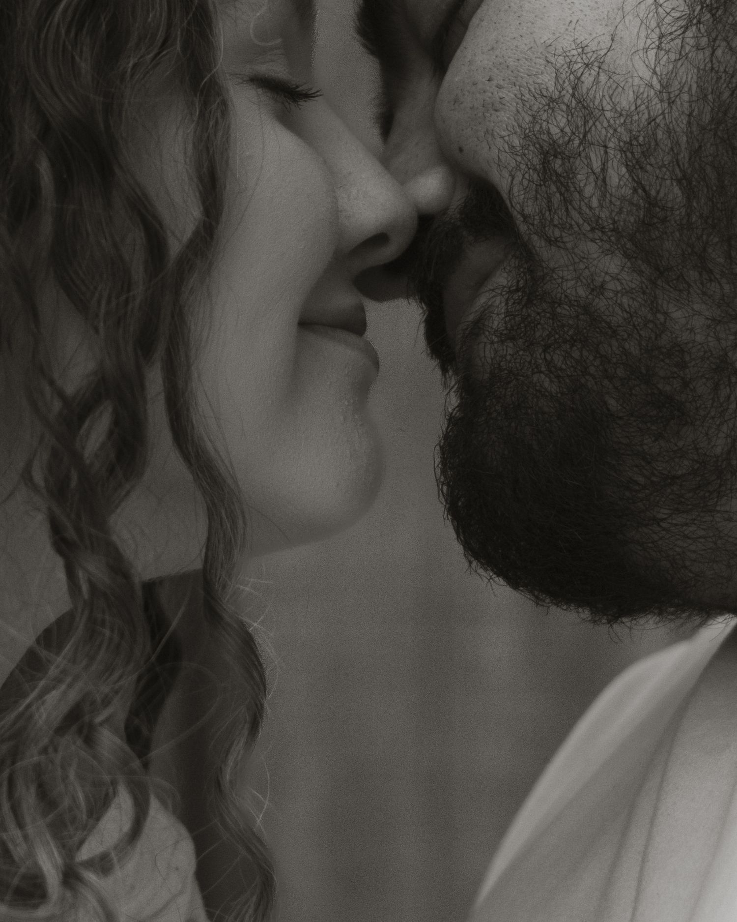 A romantic black and white sequence of intimate kisses between a couple, showing multiple angles and tender moments.