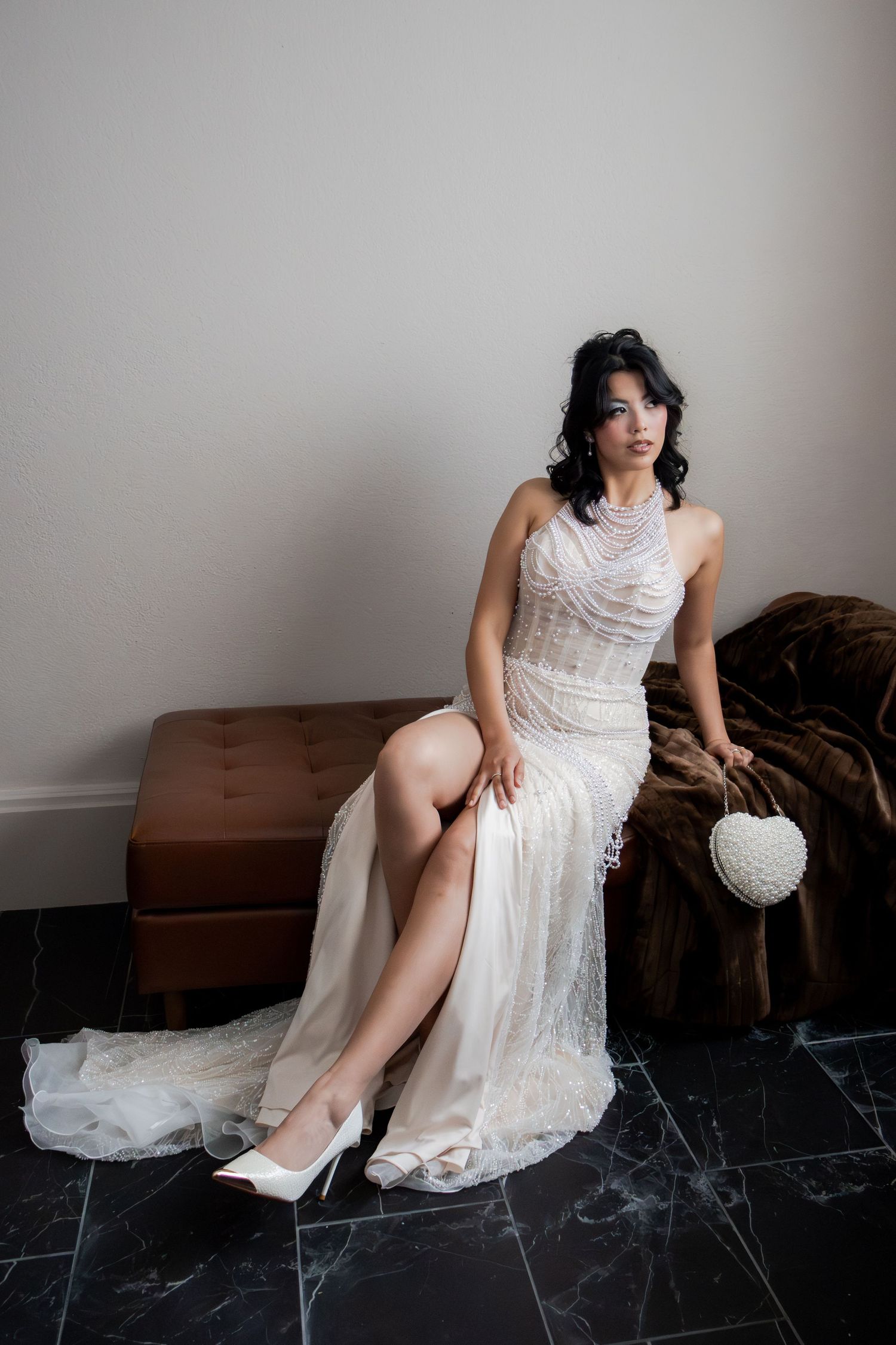 A series of artistic boudoir photos showing a person in a white lace dress posing on a dark leather couch.