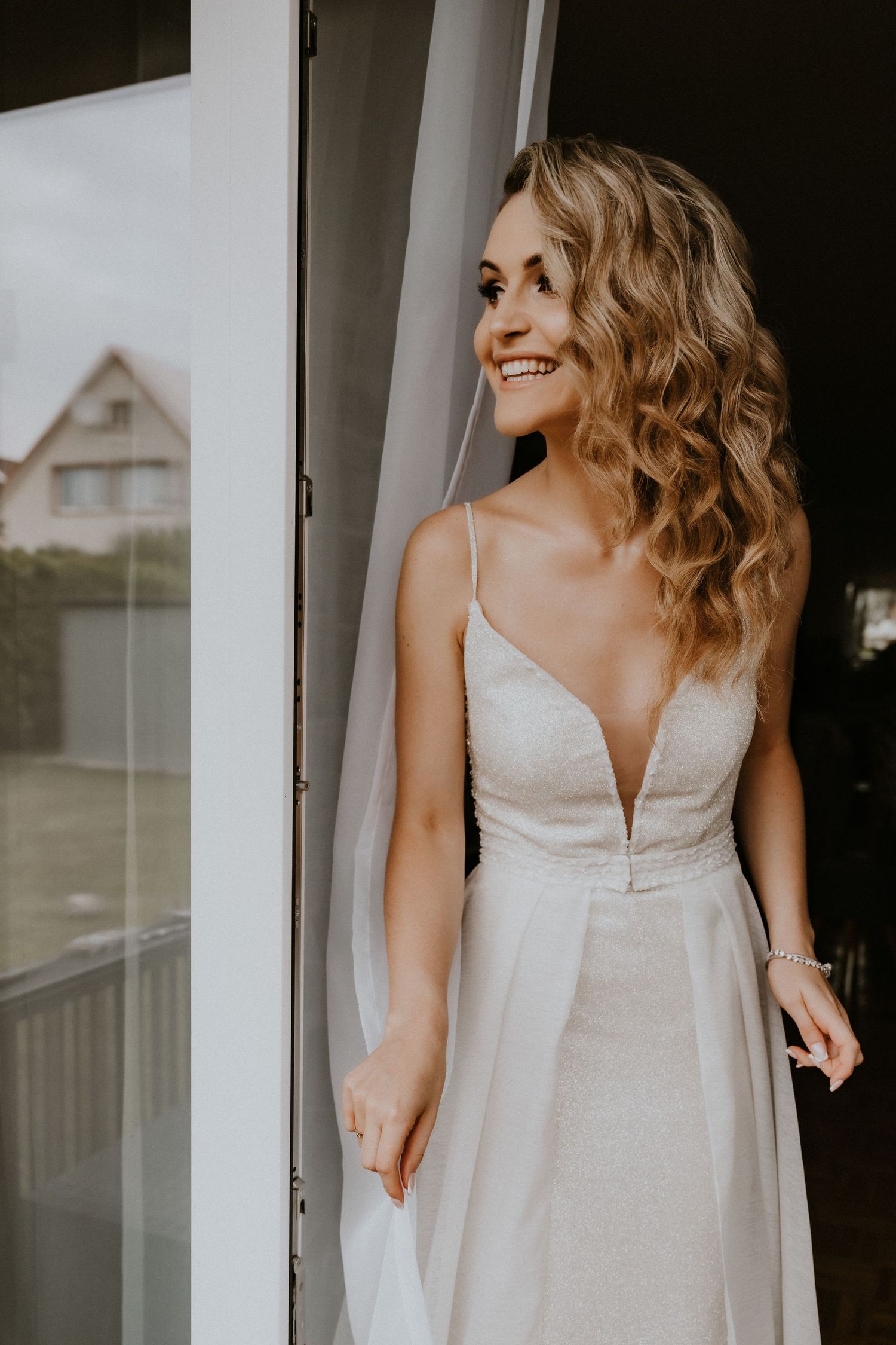 Woman in white dress photographed from different angles near a window.