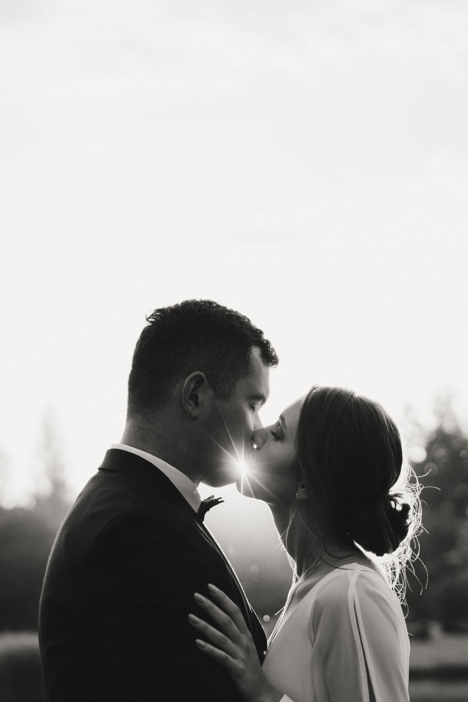 A romantic black and white photo series showing a couple in intimate silhouetted poses during a wedding photoshoot.